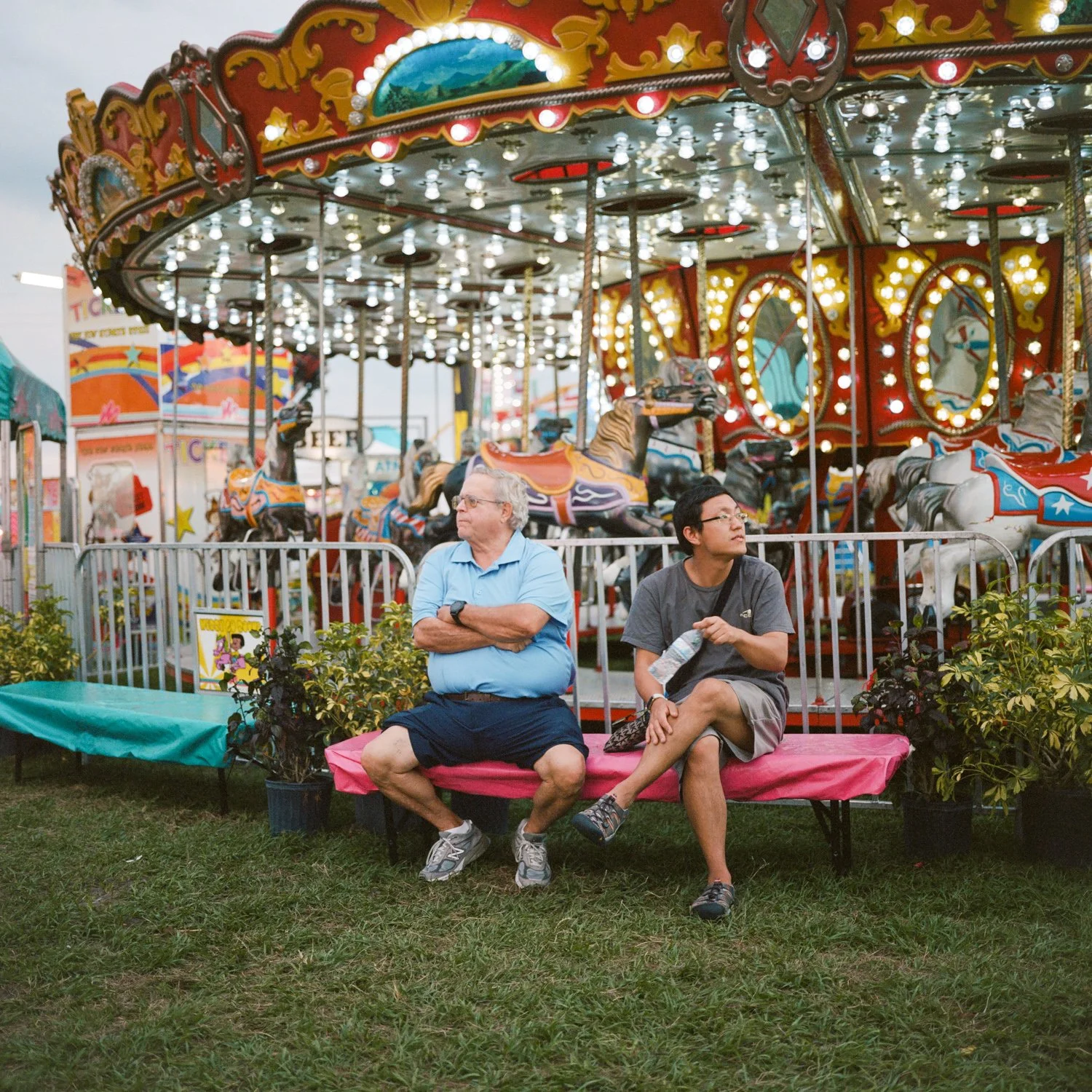 photograph of men in front of carousel