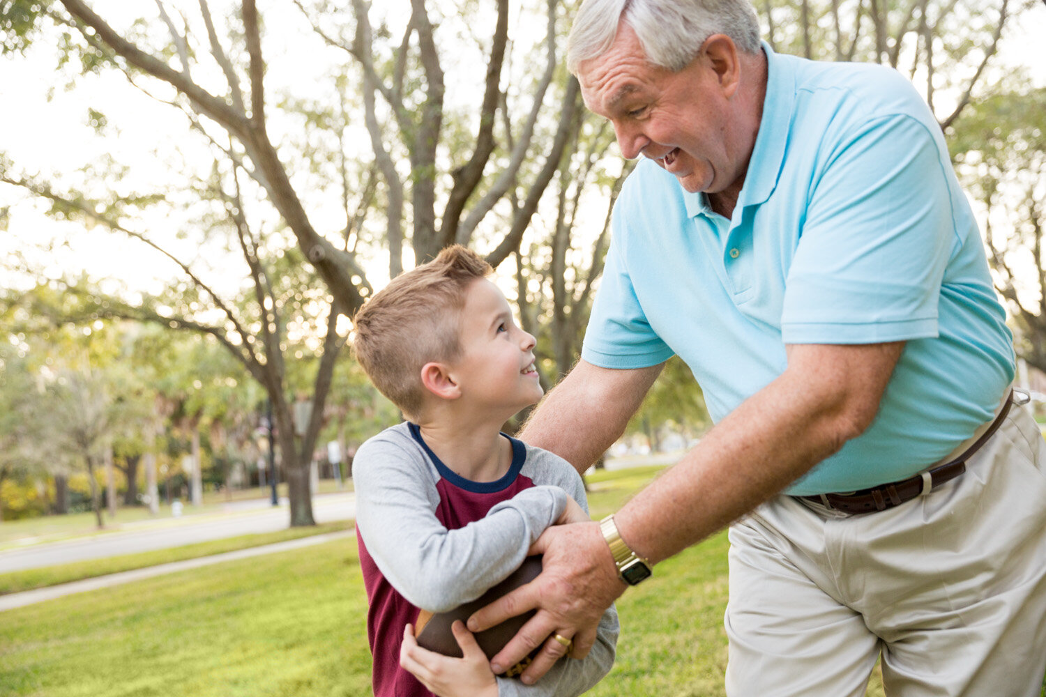 Photograph of grandfather and grandson with football