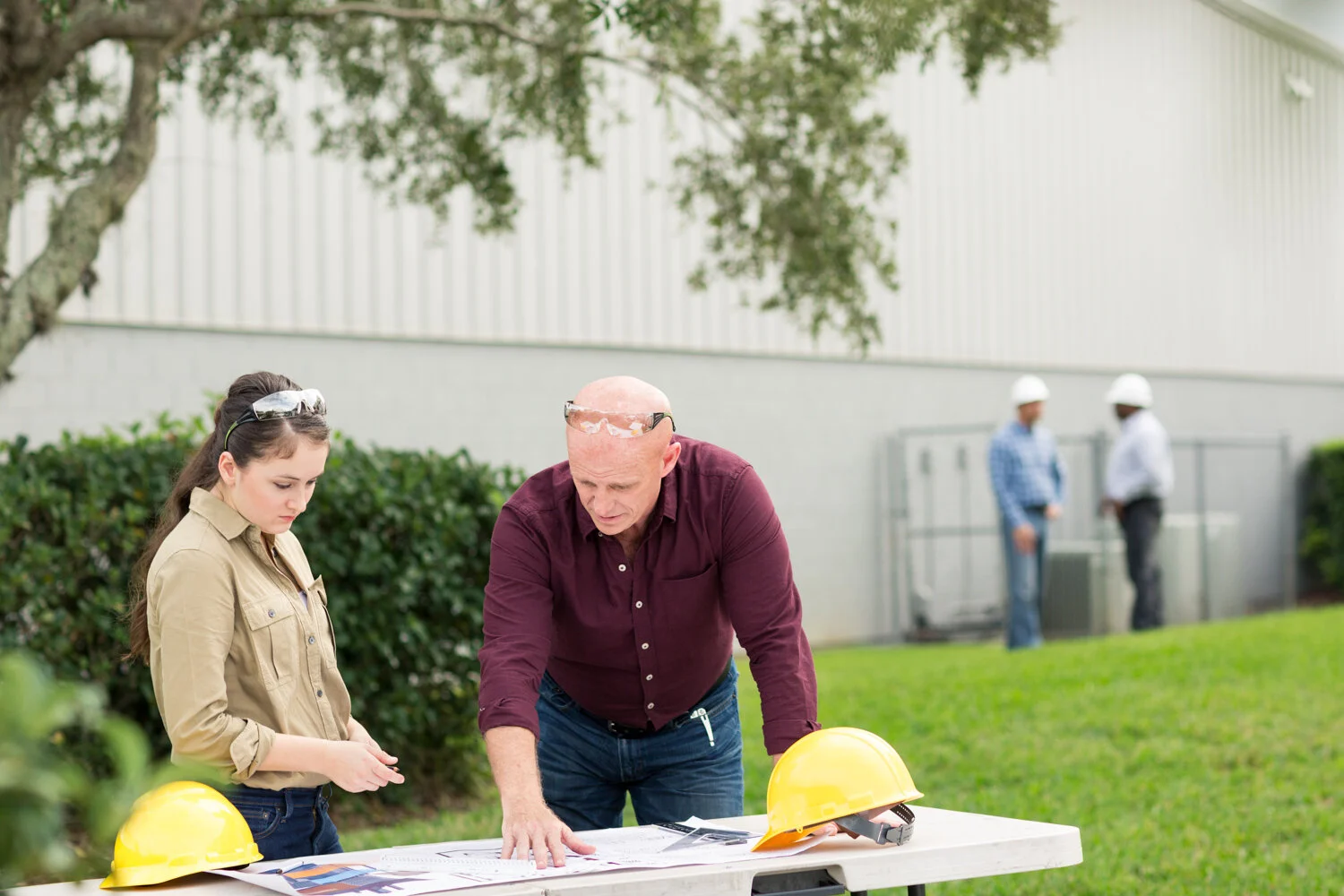 Photograph of construction foreman sharing plans