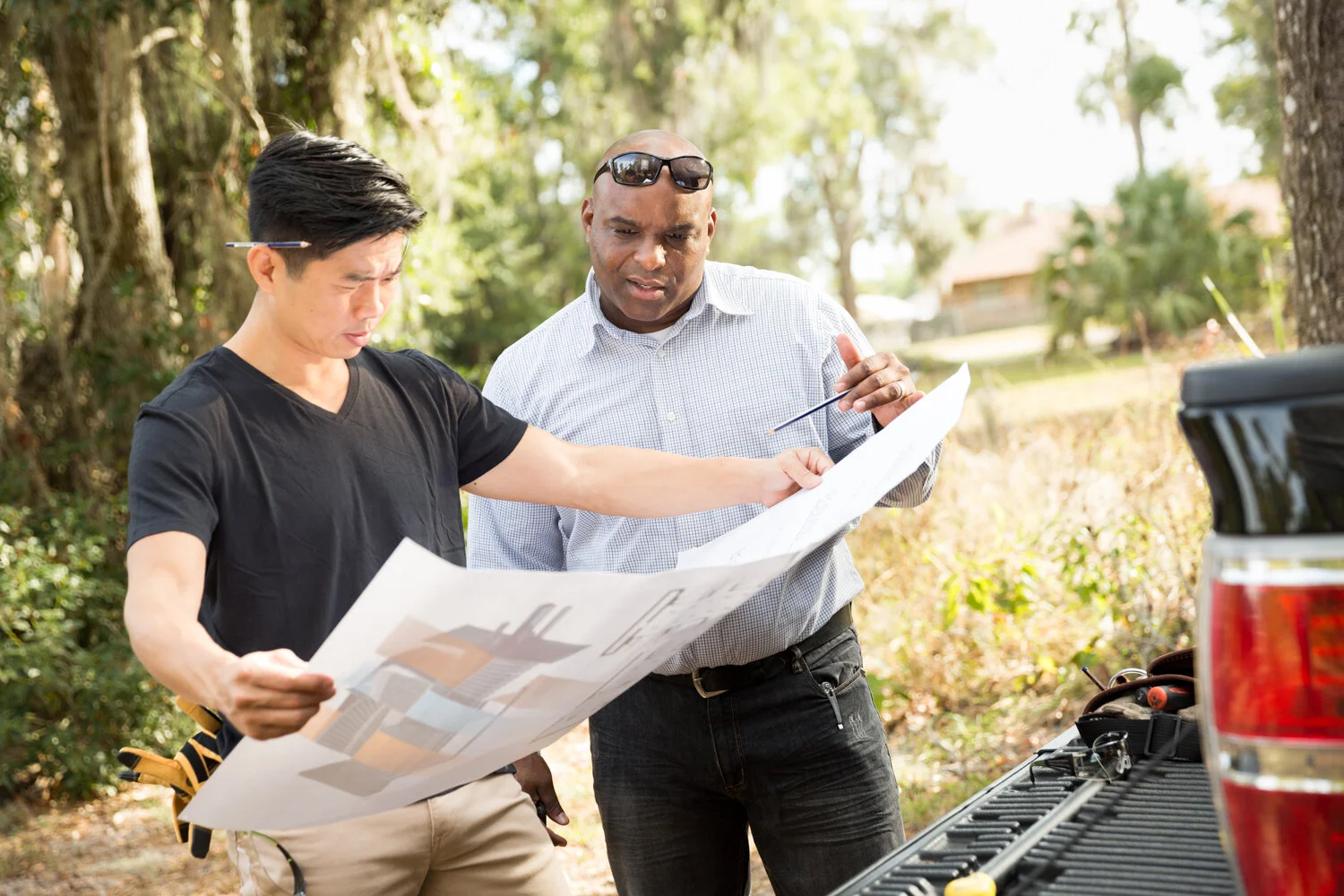 Photograph of men looking at construction plans