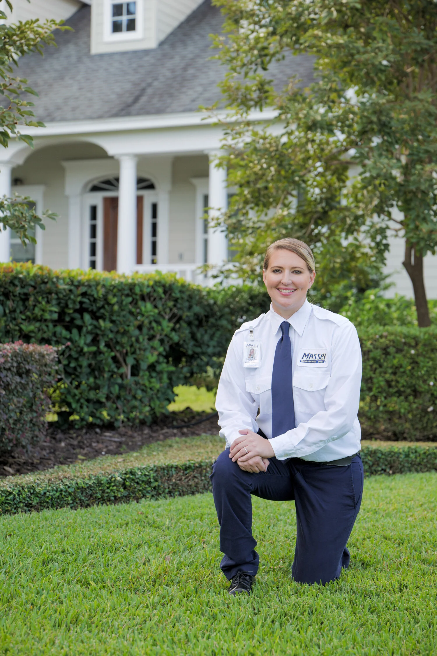 portrait of Massey Services technician kneeling in front yard