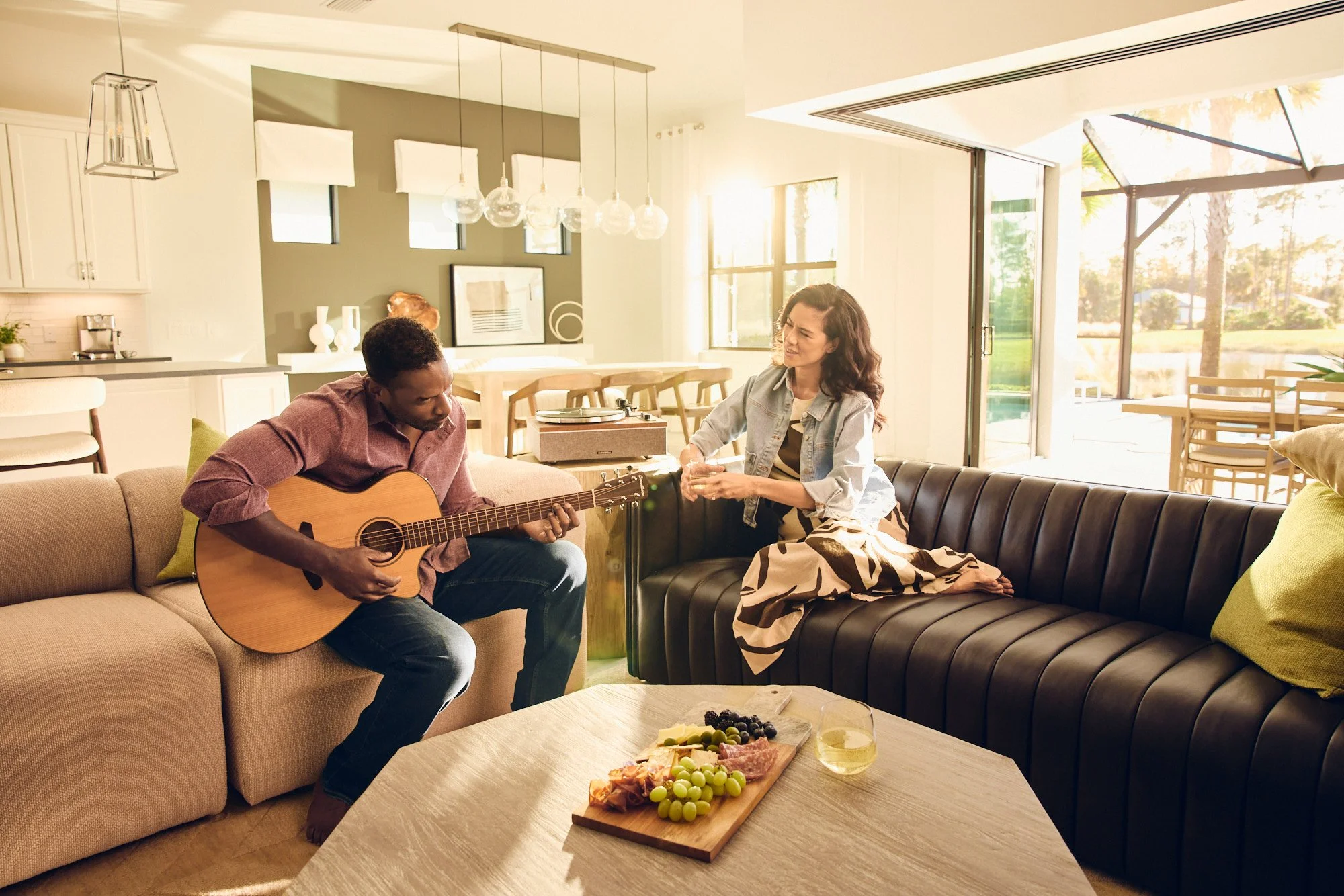 Lifestyle photo - couple playing guitar on couch - Del Webb campaign Tampa FL