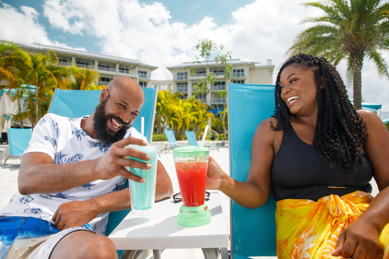 photograph of african american couple enjoying drinks at resort hotel