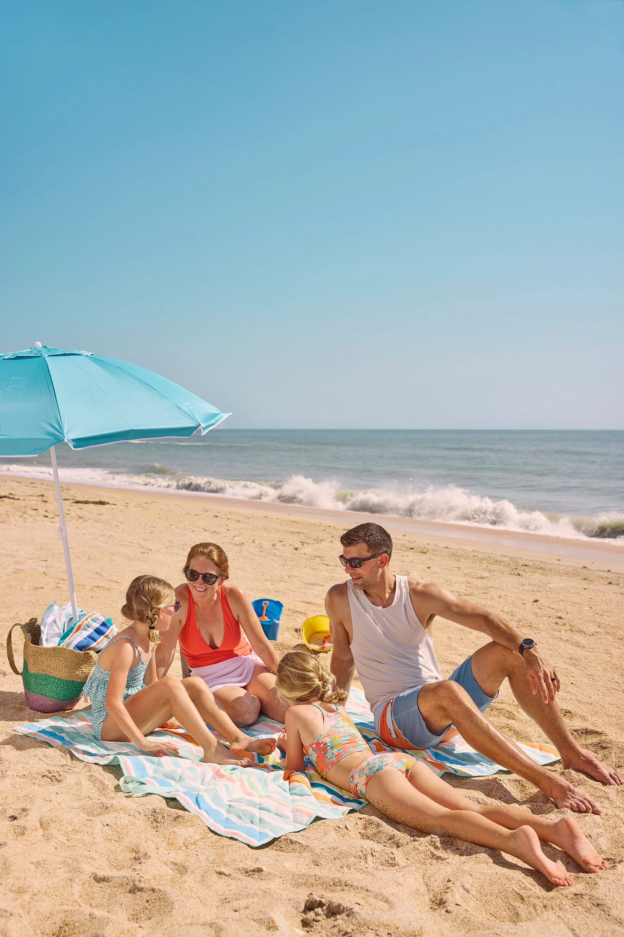 photo of family under umbrella on beach in florida