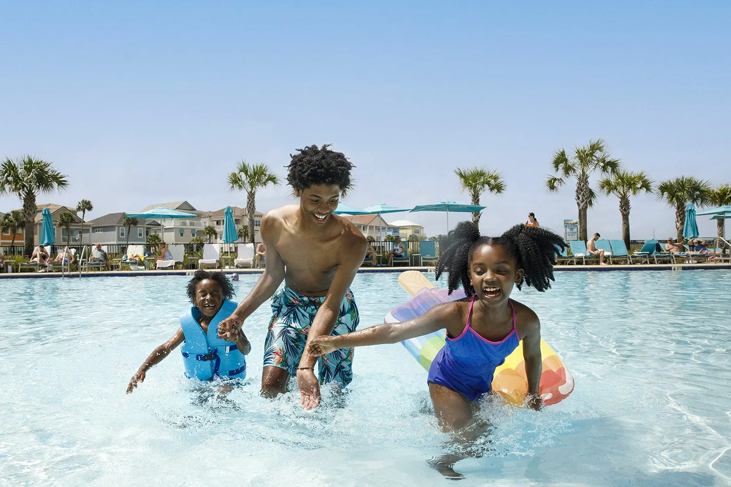 photograph of african american kids playing in pool