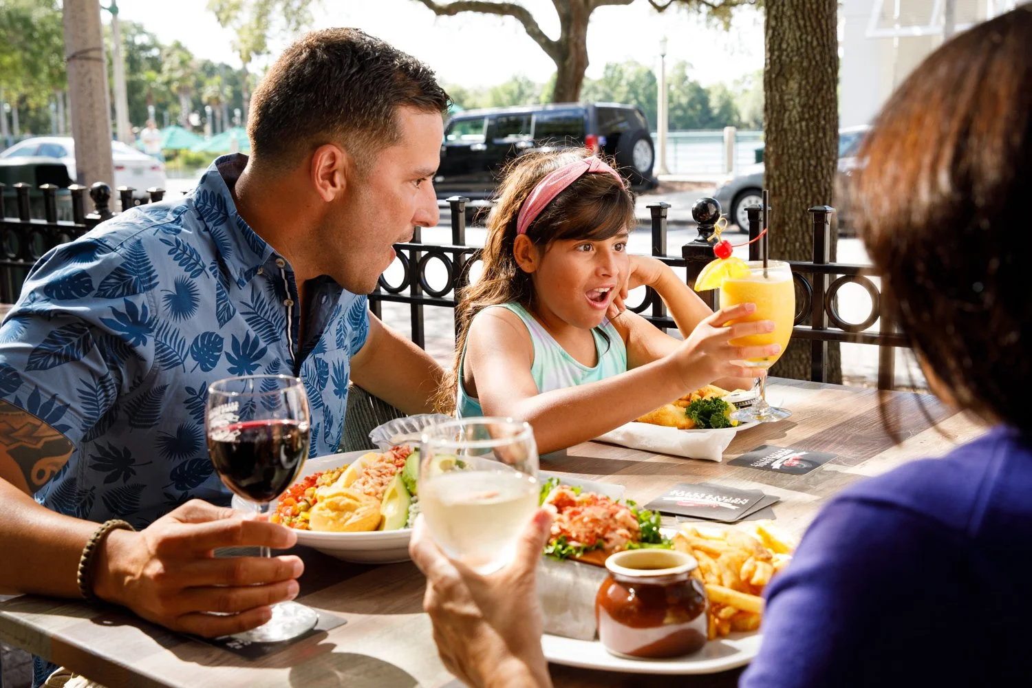 latino girl looking at drink in amazement at restaurant