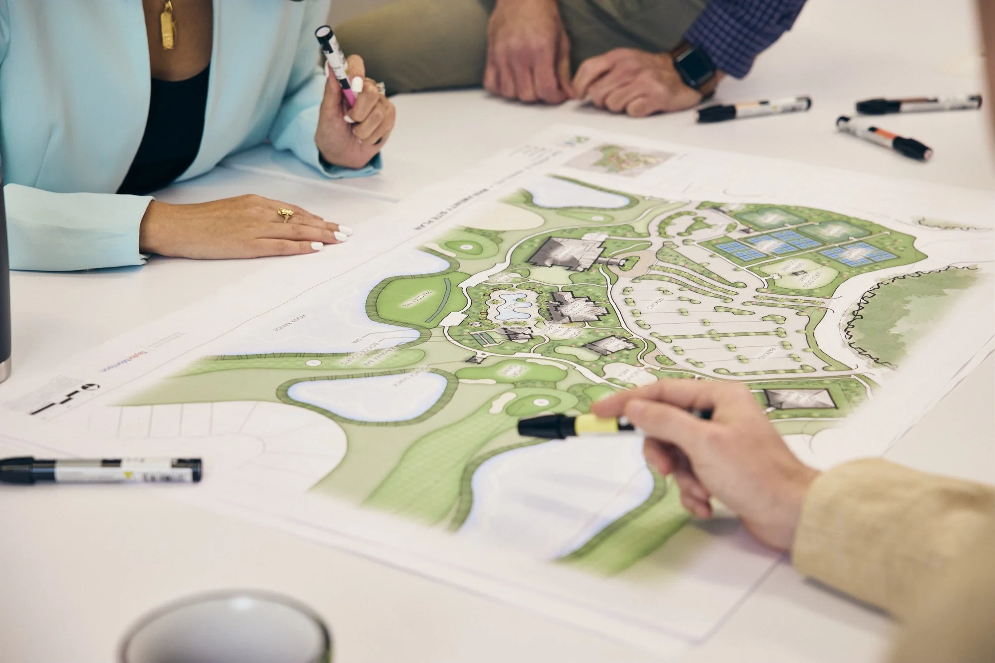 photograph of person pointing to landscape plans
