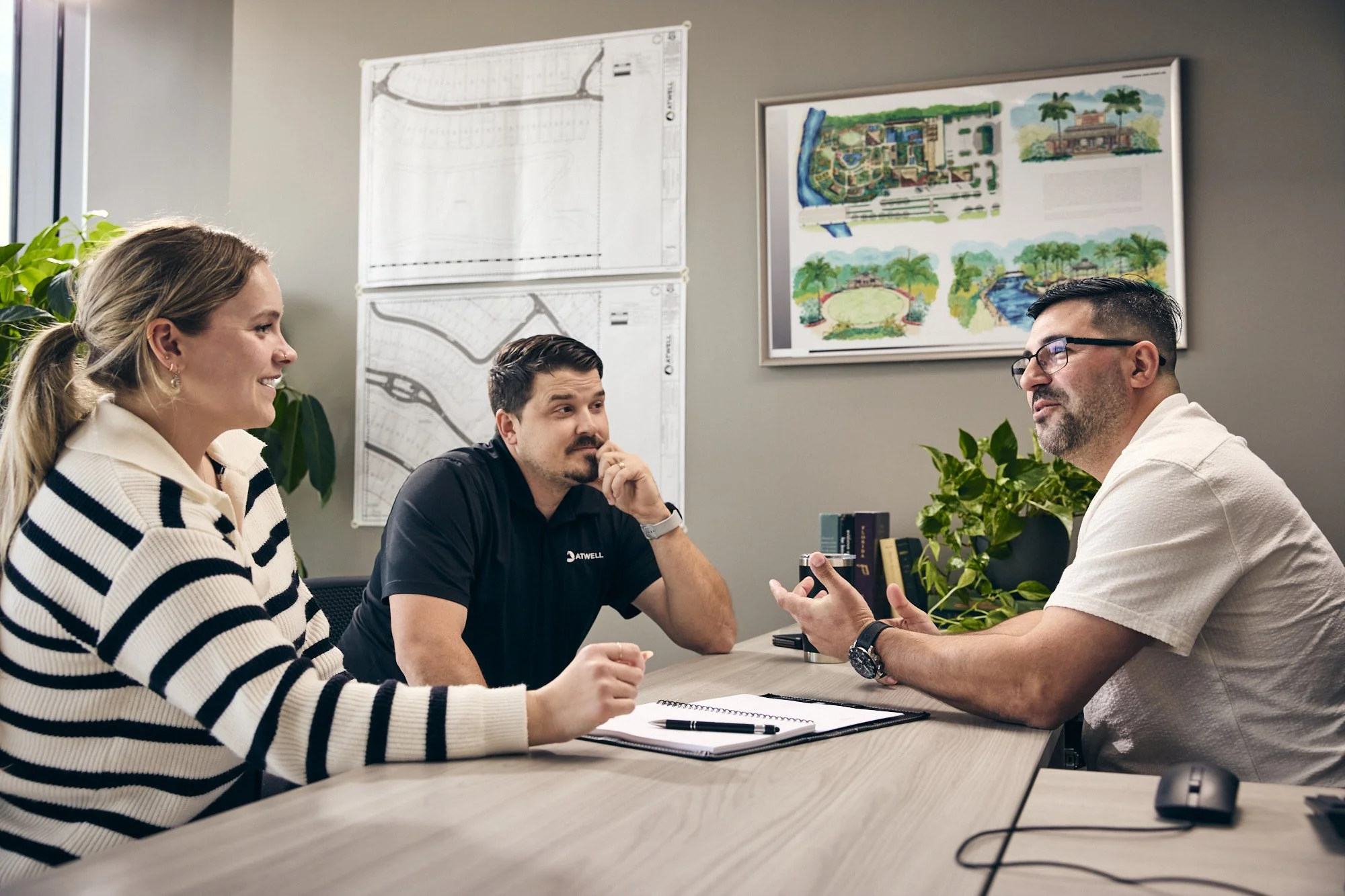 photograph of boss meeting with employees in office