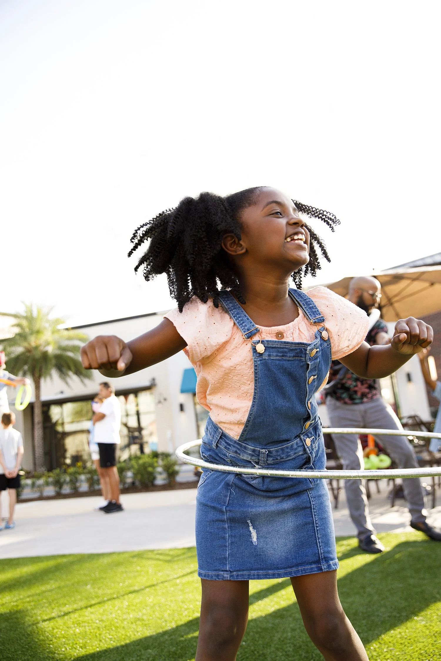 photograph of african american girl playing hula hoop