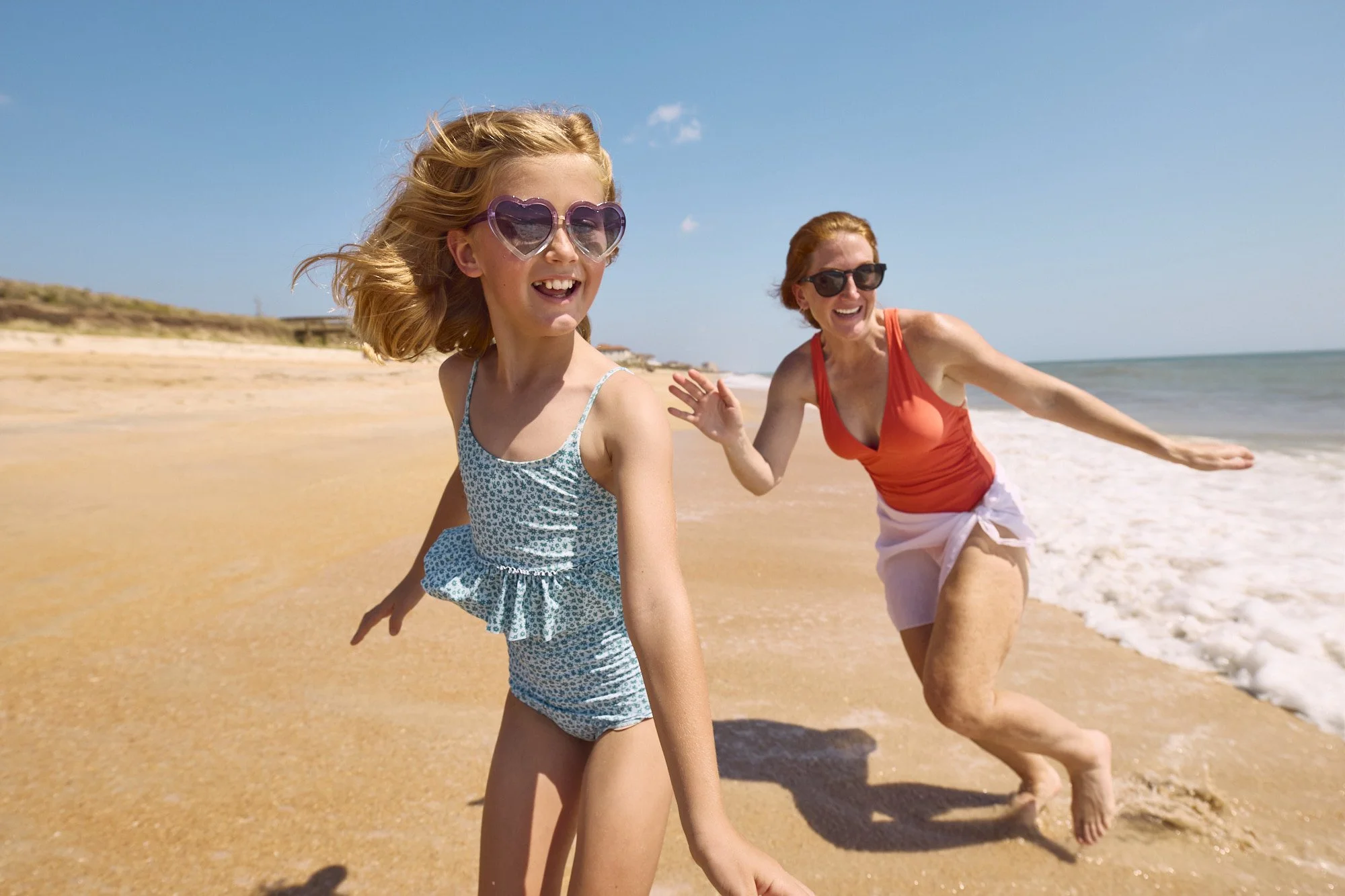 photo of girl and mother running from waves on Florida beach