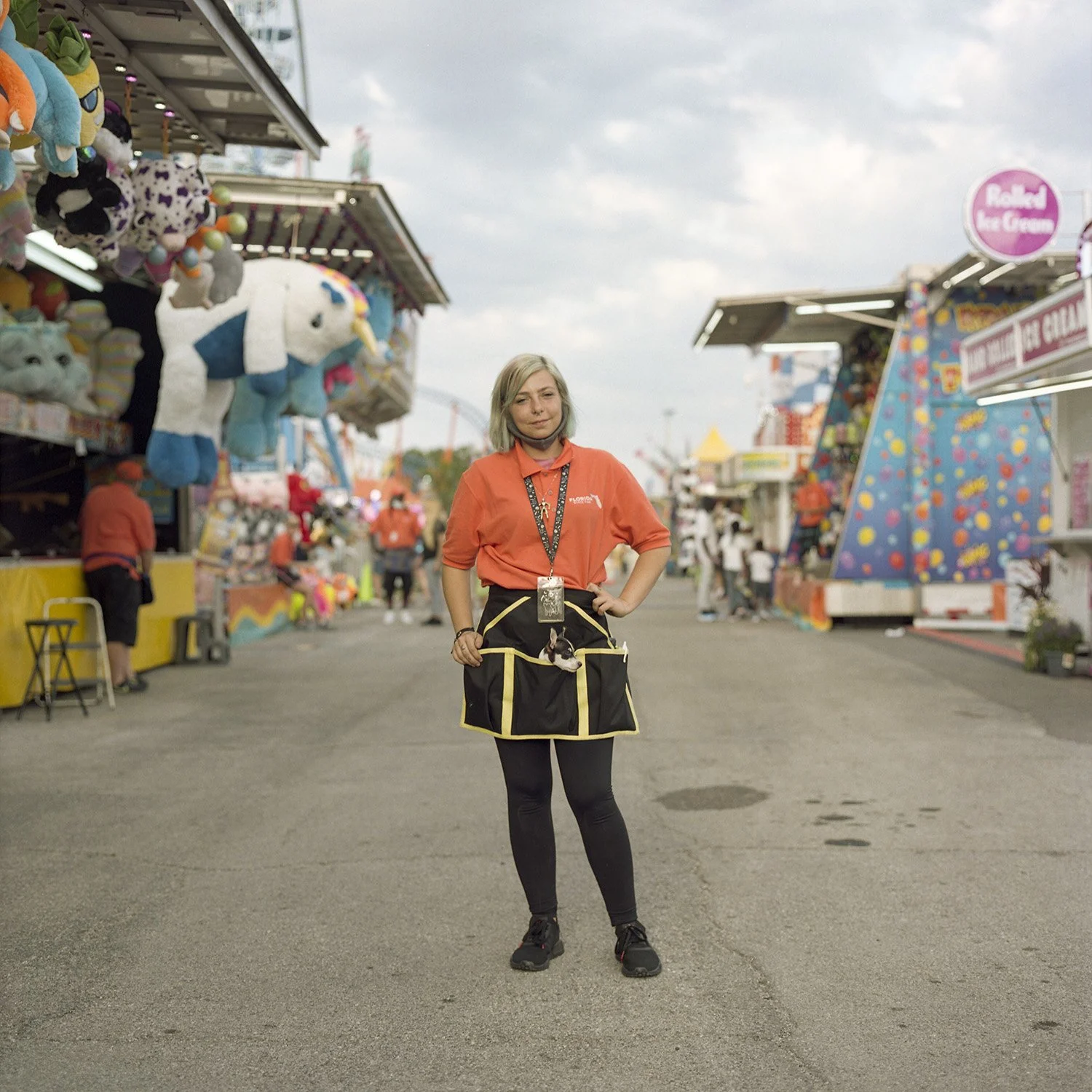photograph of carnival worker with puppy