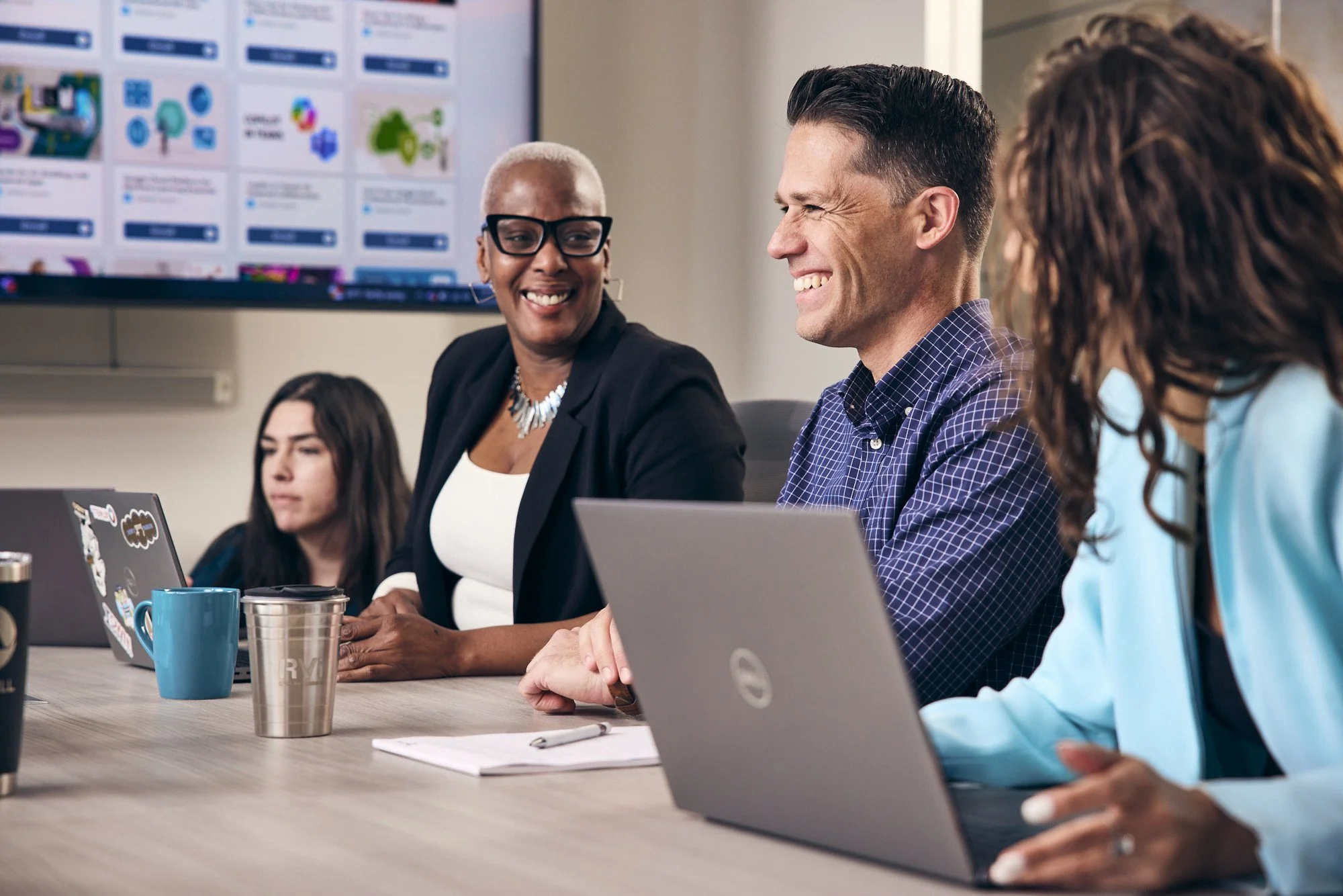 photograph of people laughing during board meeting