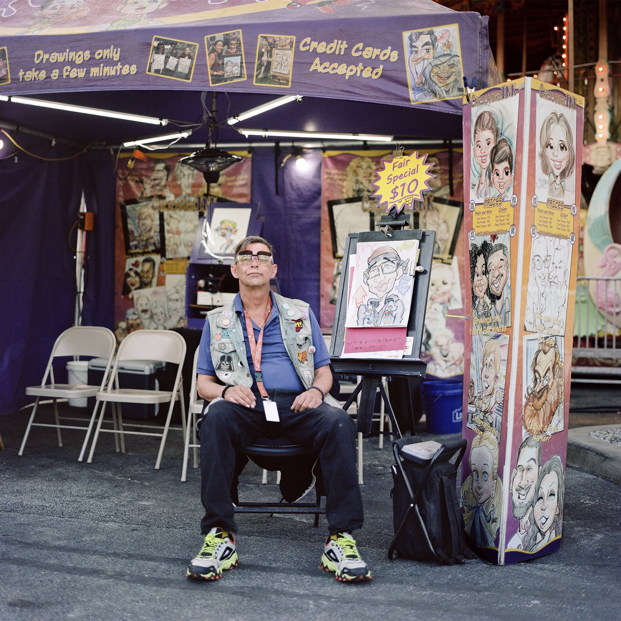 Photograph of a caricature artists at a fair and carnival