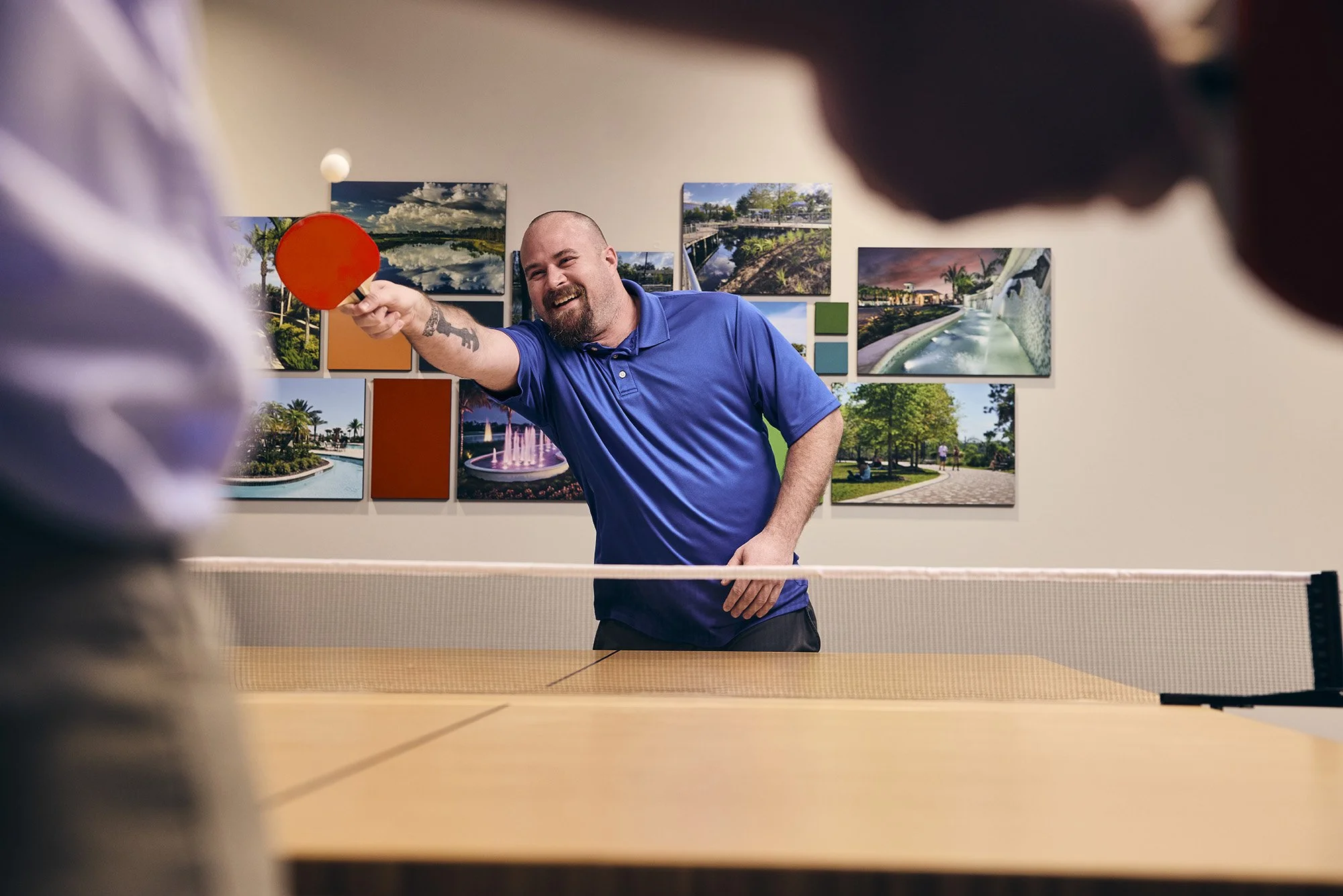 photograph of men playing ping pong at work