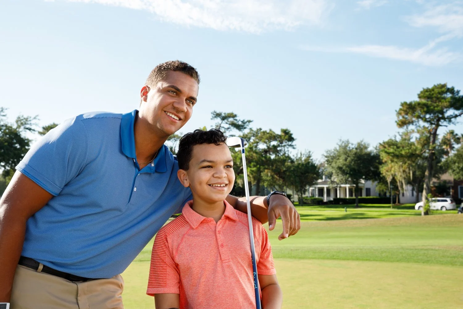 photograph of father and son playing golf