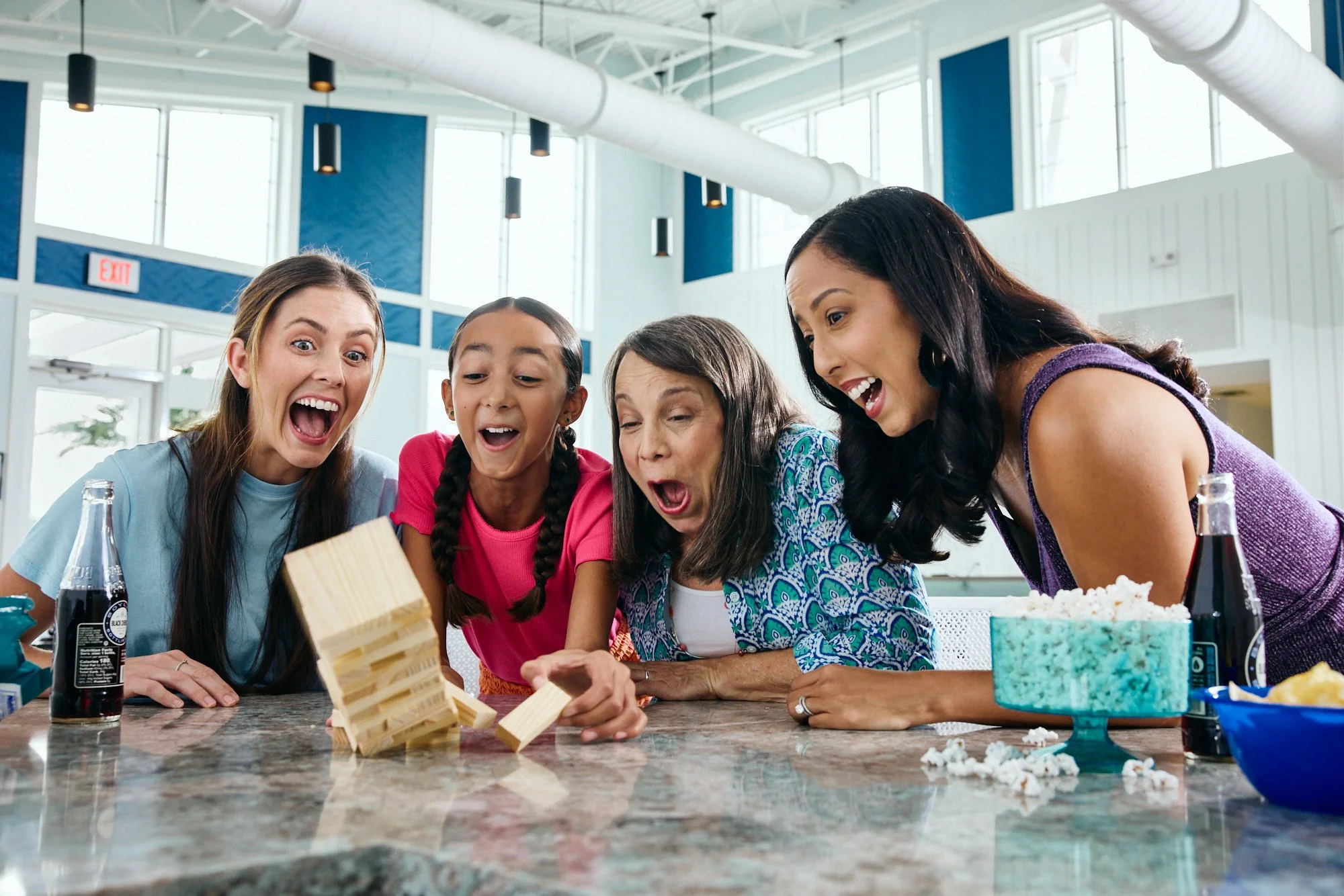 Lifestyle photo of four women playing Jenga in the Meridian Parks clubhouse