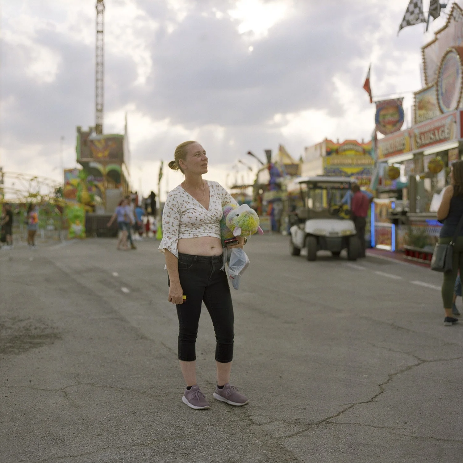 photograph of woman watching carnival