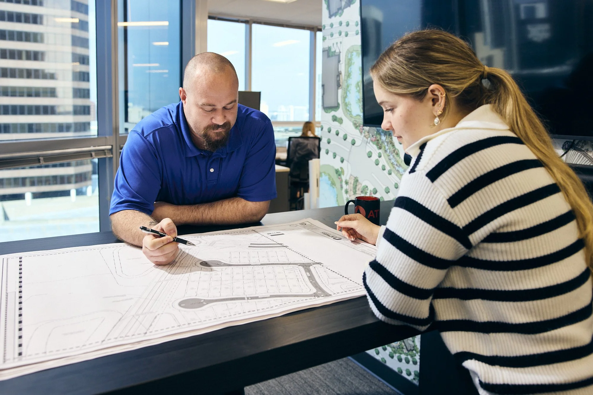 photograph of people working on architecture plans