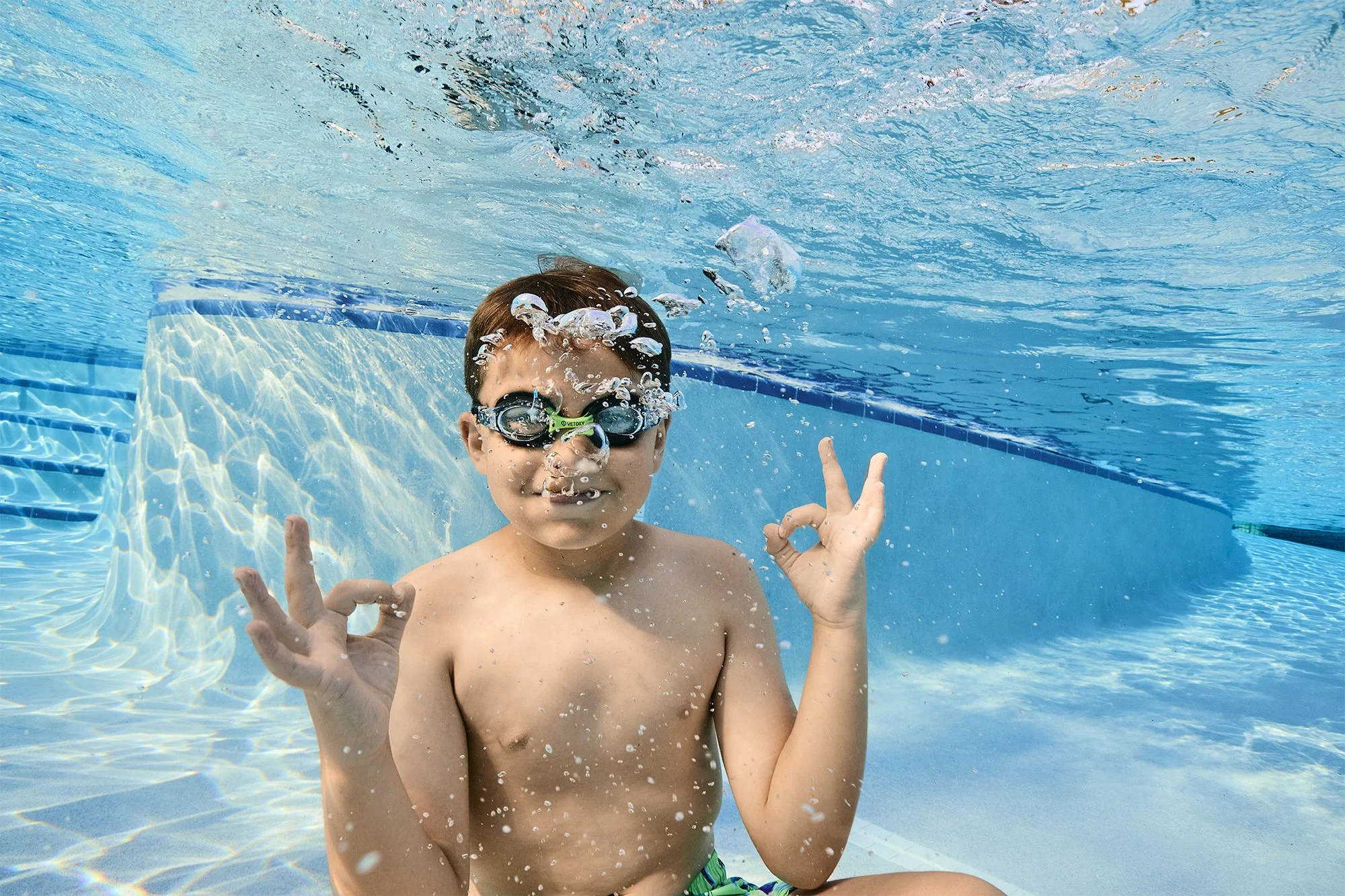 Underwater photo of a boy in goggles in a master-planned community pool