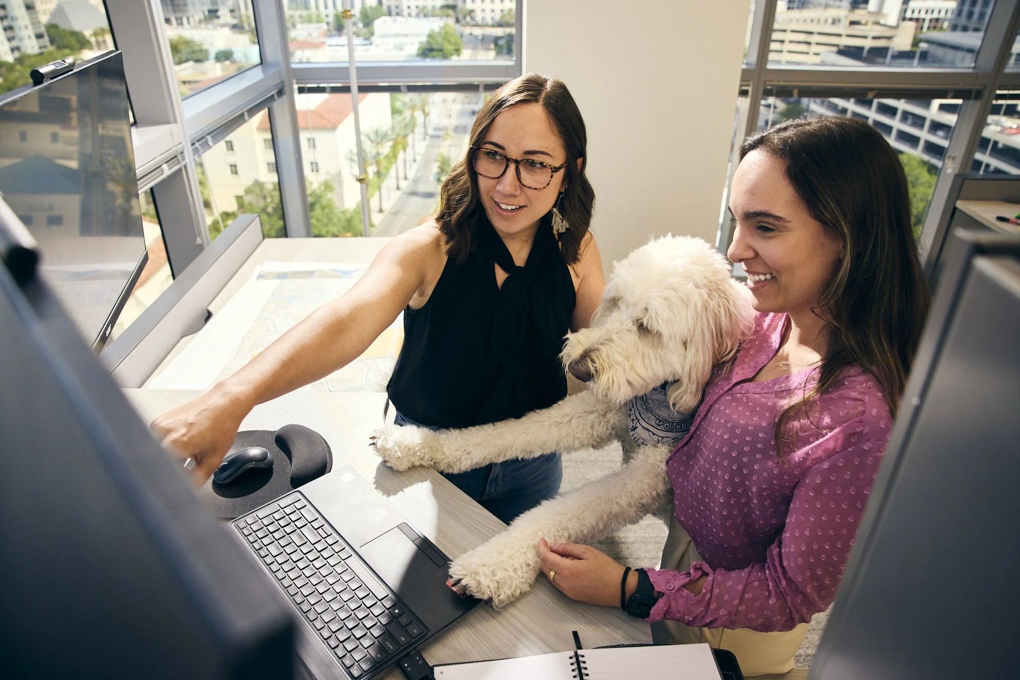 photograph of women working over a computer