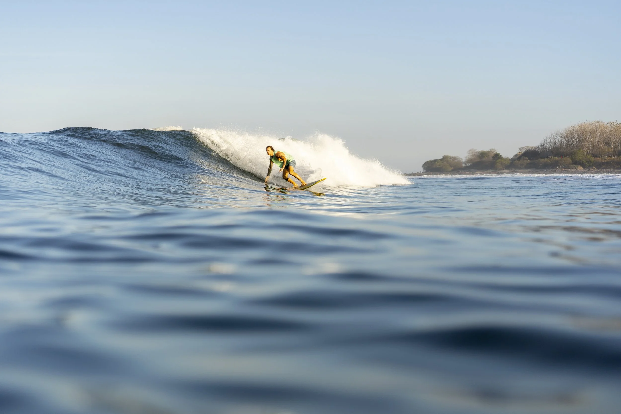 Surfer riding a wave on Northern Nicaragua's uncrowded Pacific coast at a surf camp