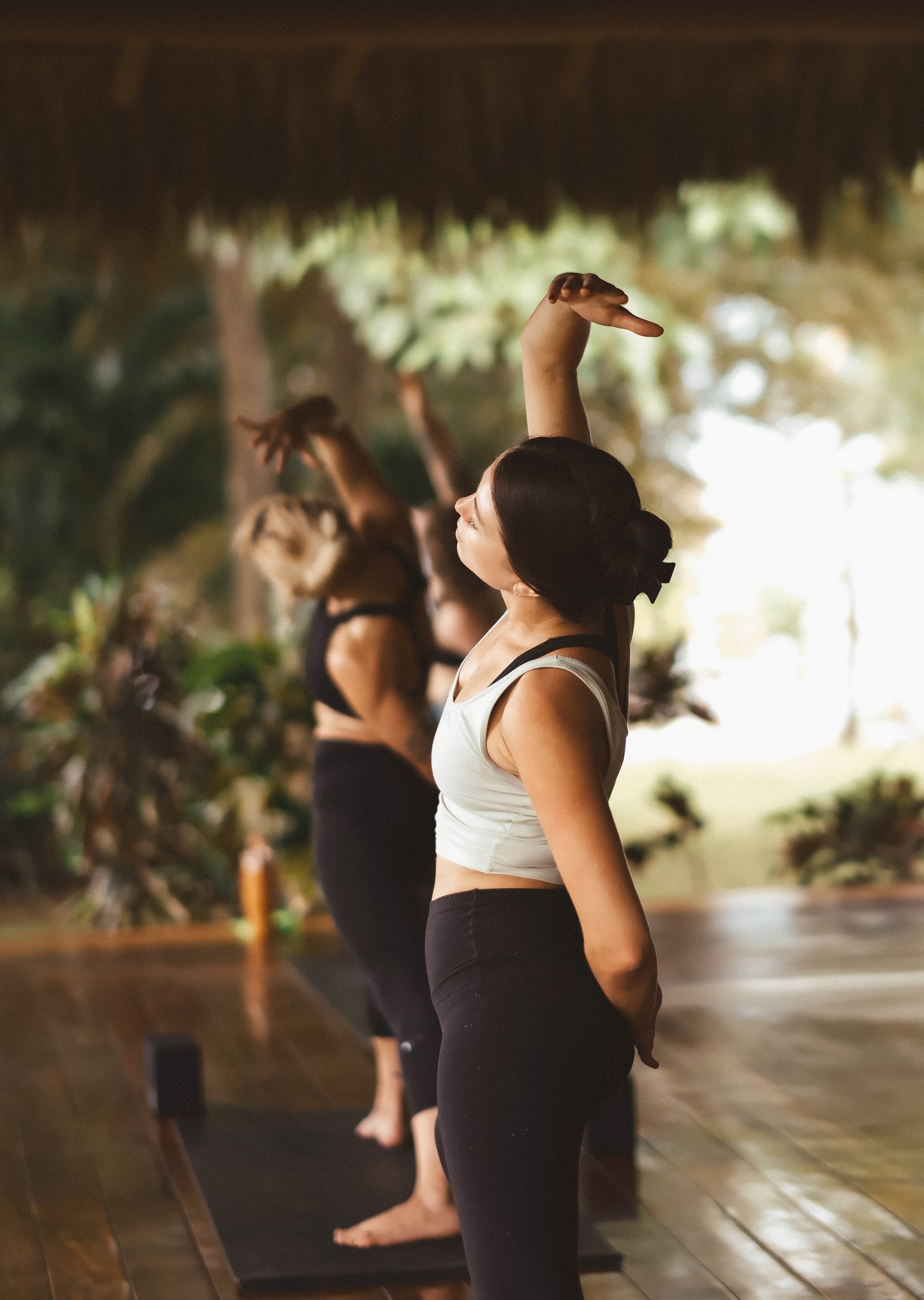 Yoga students stretching in the open-air shala at Still Salty Escape during a yoga retreat in Nicaragua