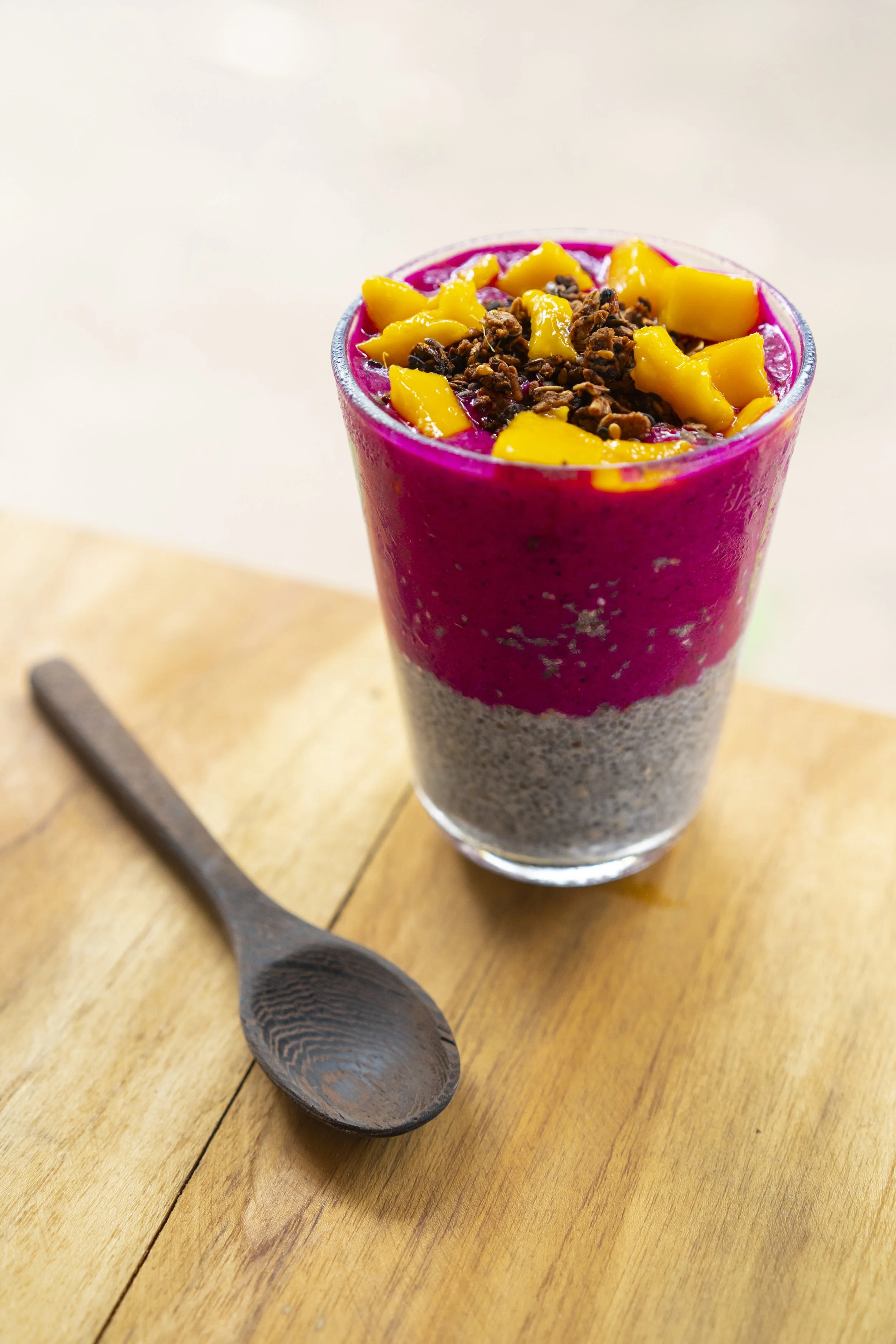 Dragon fruit and chia pudding parfait topped with mango and granola at a farm-to-table retreat in Nicaragua