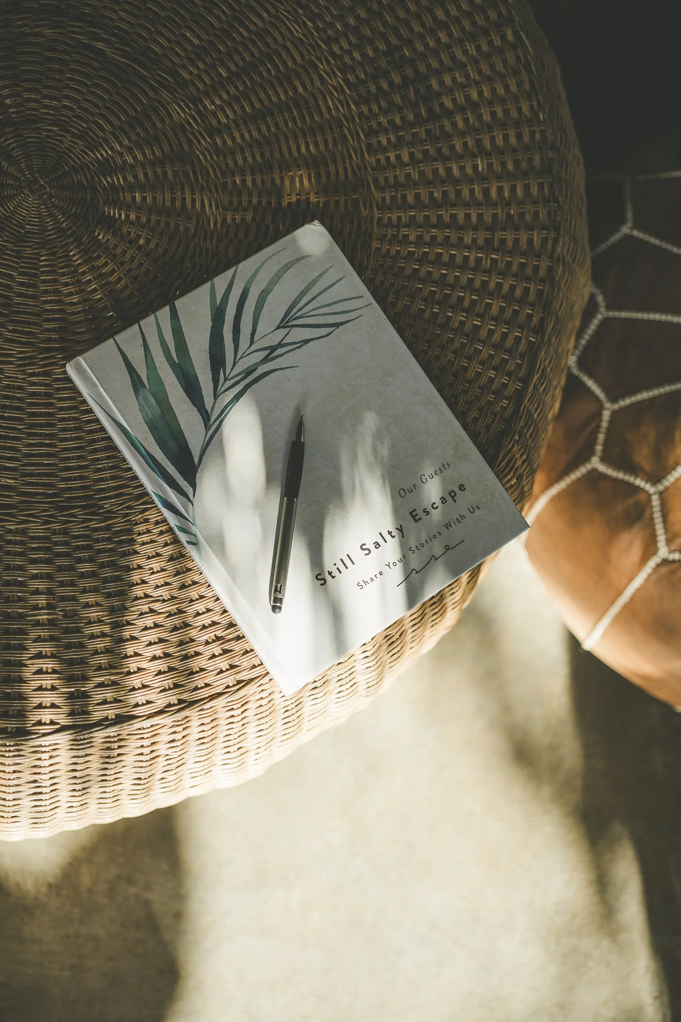 Still Salty Escape guest journal and pen on a woven pouf at the retreat venue in Nicaragua