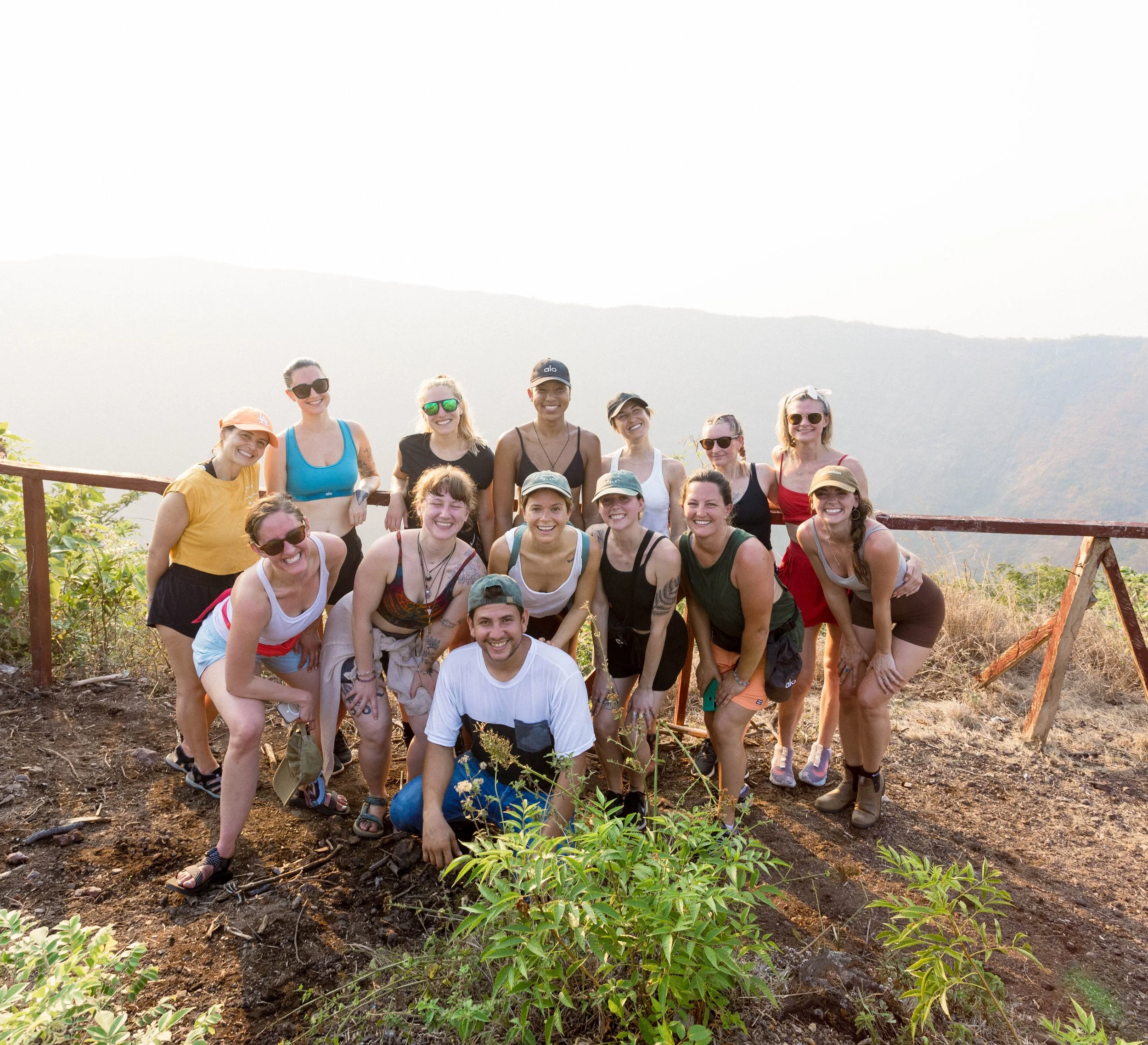 Retreat group posing together at the Cosigüina crater overlook after a volcano hike in northern Nicaragua