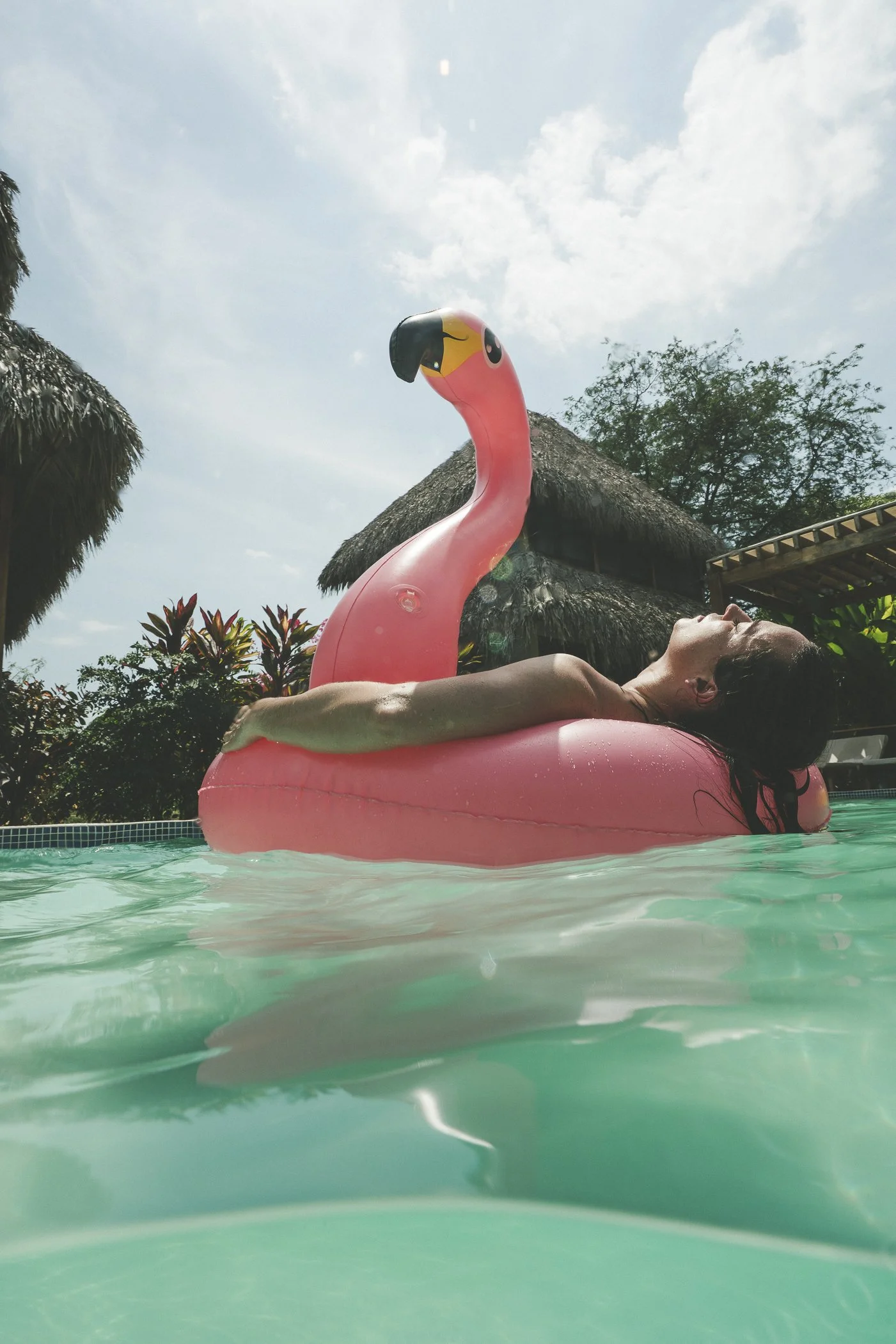 Guest relaxing on a flamingo float in the pool during an afternoon break at a remote work retreat in Nicaragua