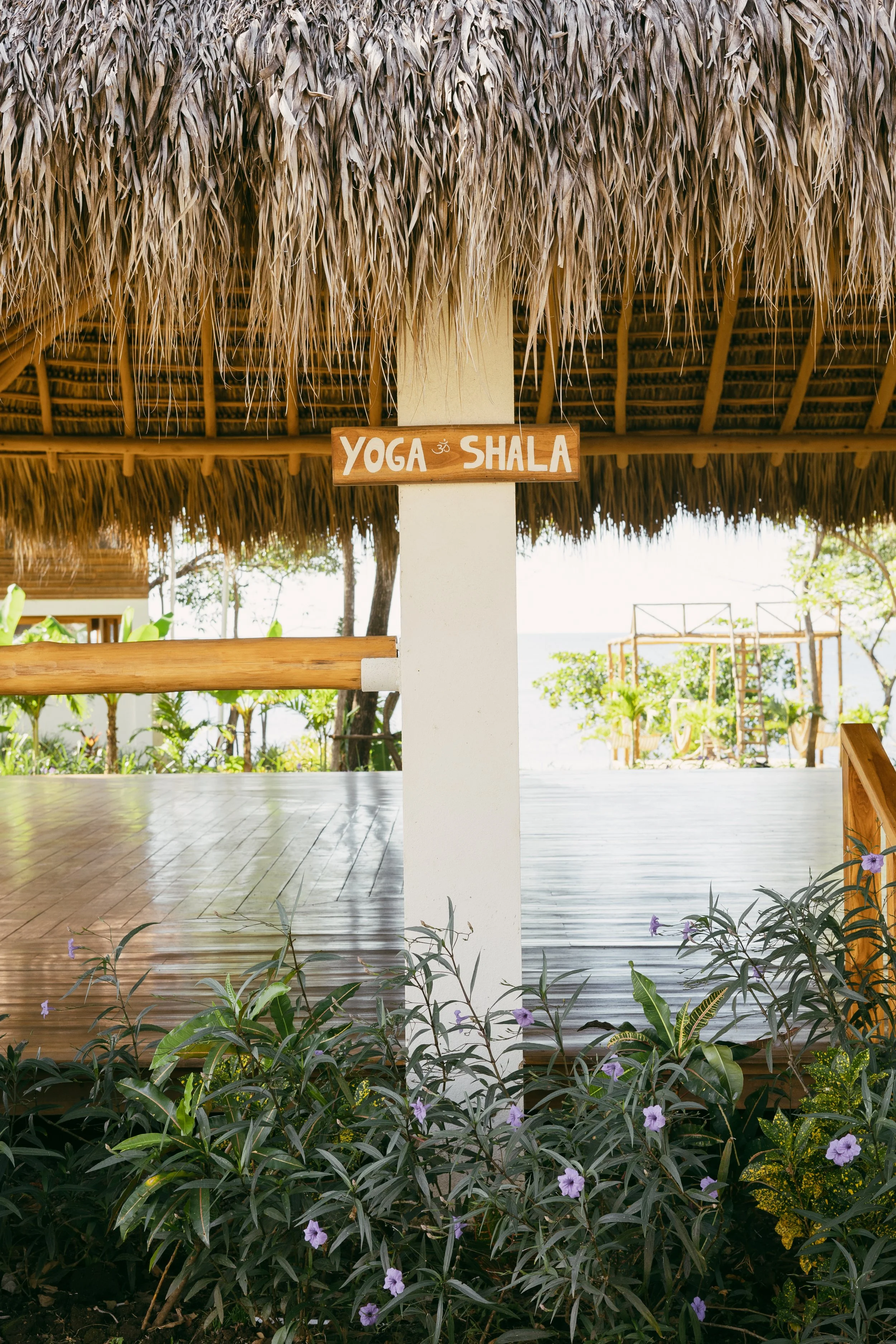 Hand-painted Yoga Shala sign on the open-air deck overlooking the ocean at Still Salty Escape retreat in Nicaragua