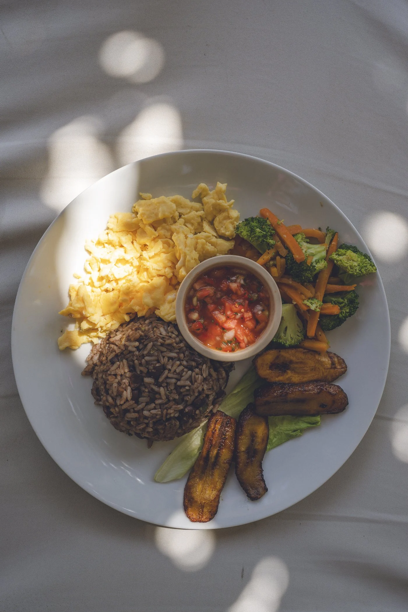 Traditional Nica Plate breakfast with gallo pinto, scrambled eggs, fried plantains, sautéed vegetables, and pico de gallo at Still Salty Escape in Nicaragua
