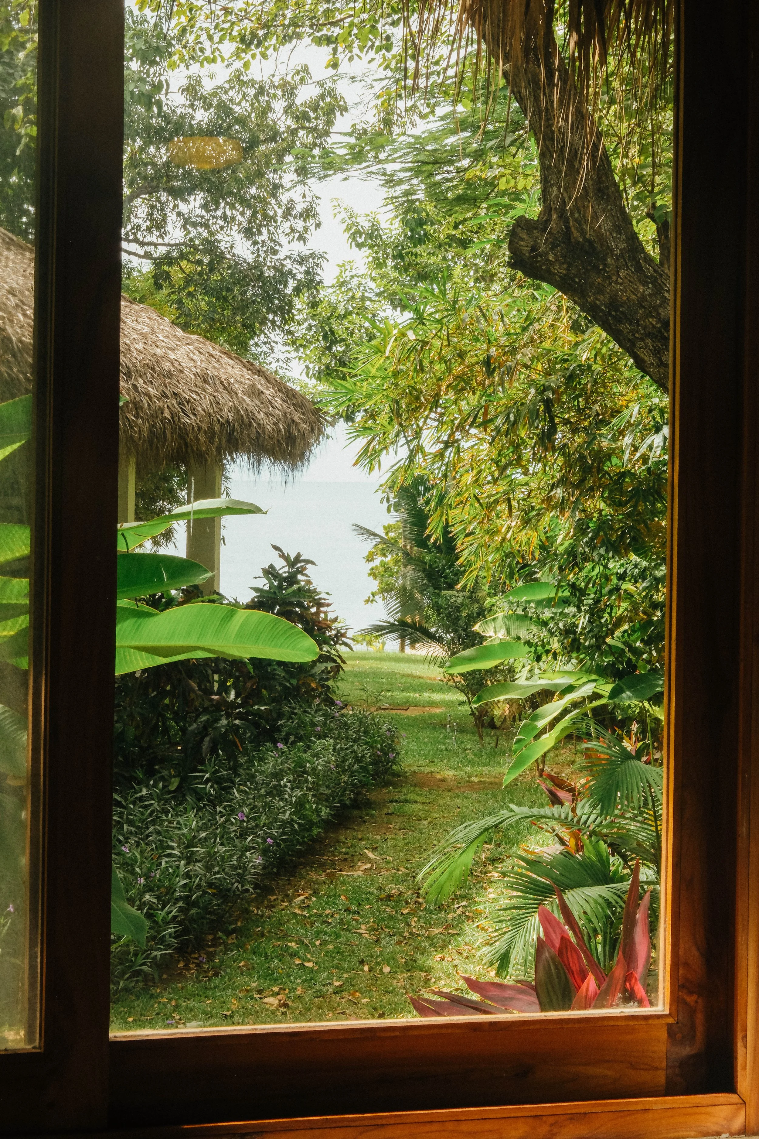Ocean view and yoga shala framed by tropical gardens from the lower Mango room at Still Salty Escape retreat in Nicaragua