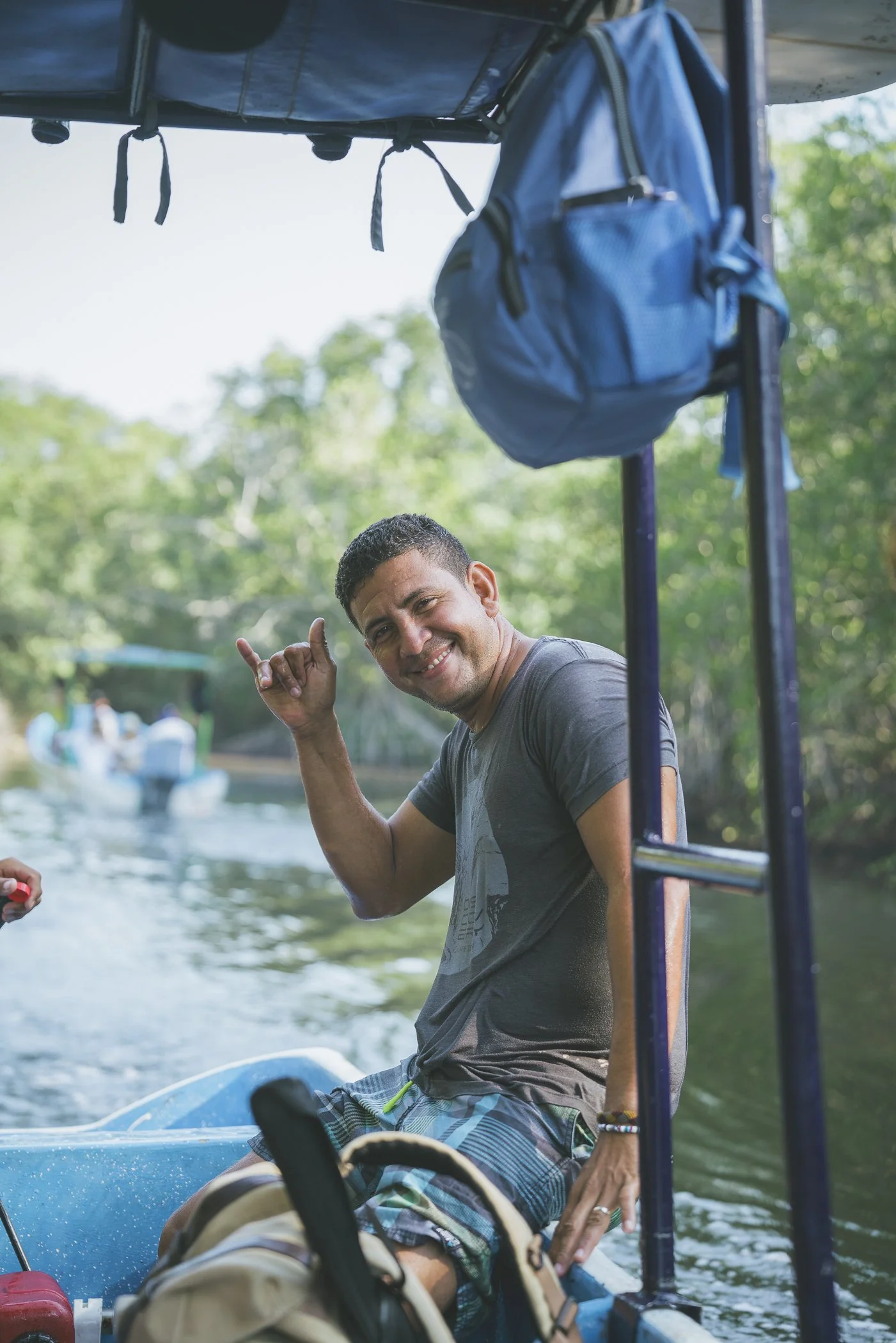 Rafa, a local guest-facing manager, smiling and throwing a shaka on a mangrove boat tour in Nicaragua