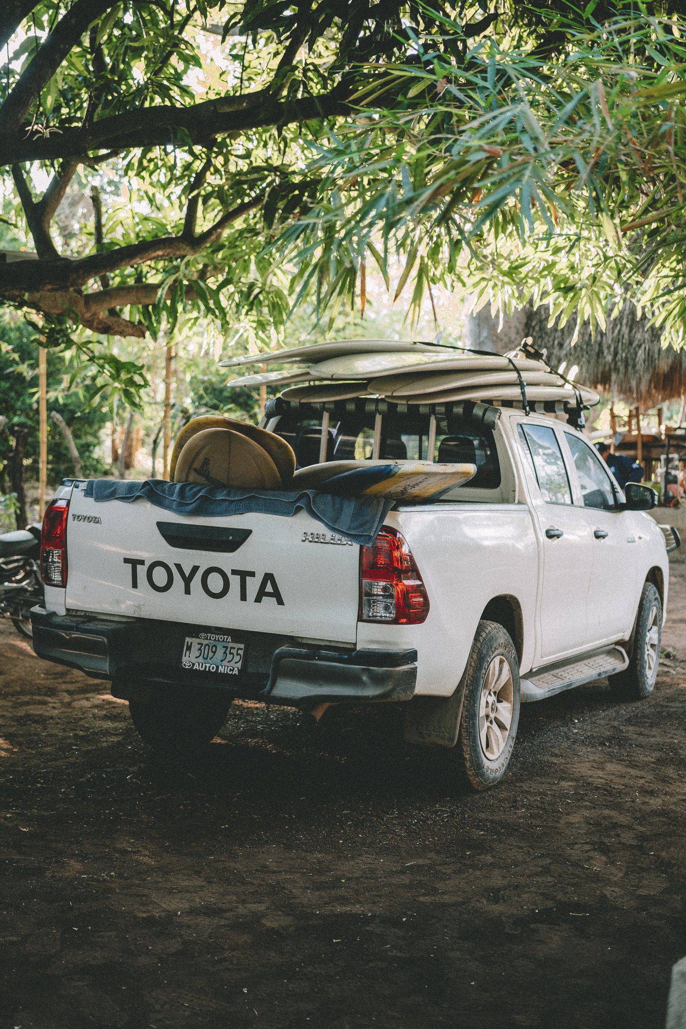Pickup truck loaded with surfboards ready for transport to the breaks at a surf retreat in Nicaragua