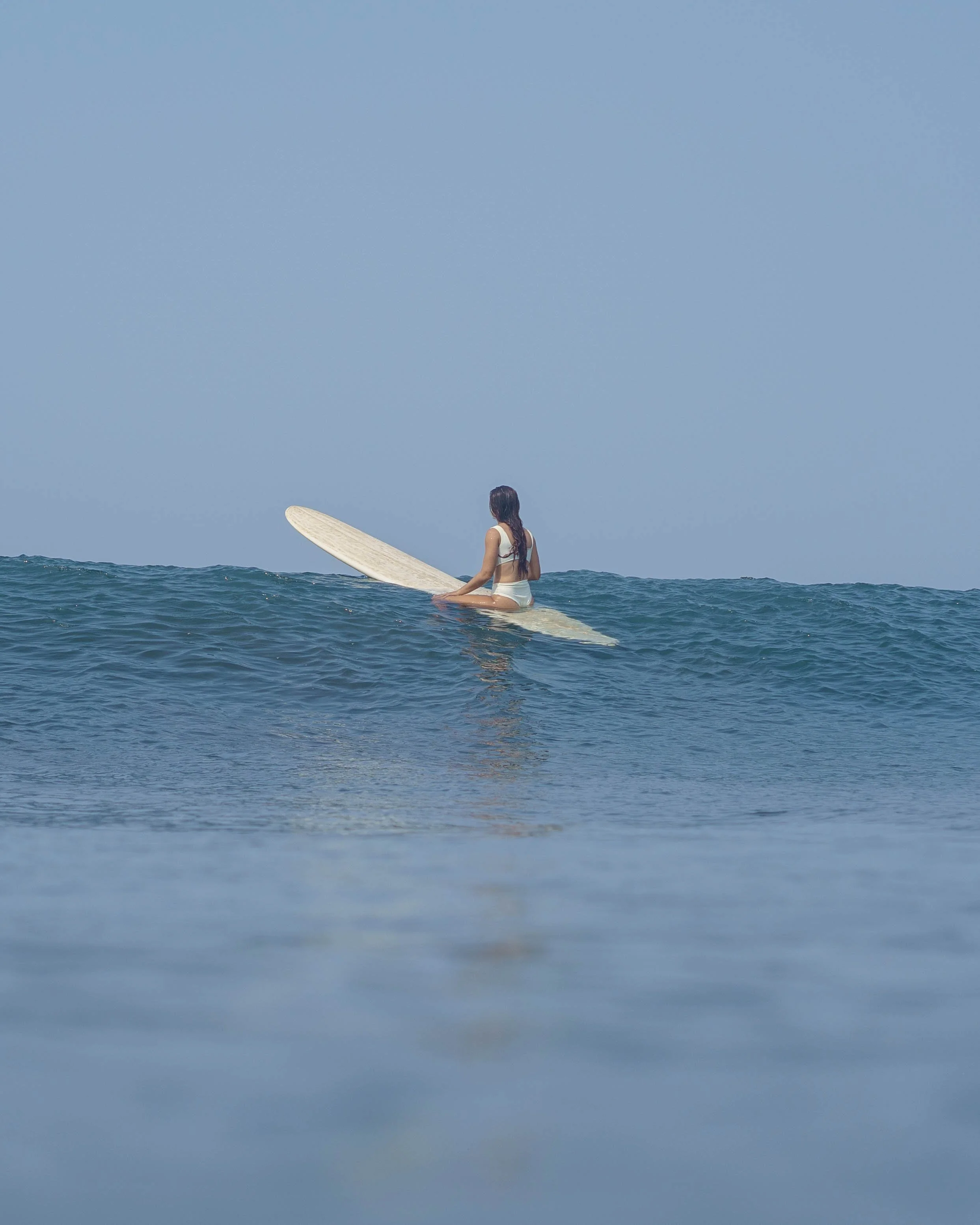 beginner surfer learning to surf on a longboard at Still Salty Escape surf camp Nicaragua