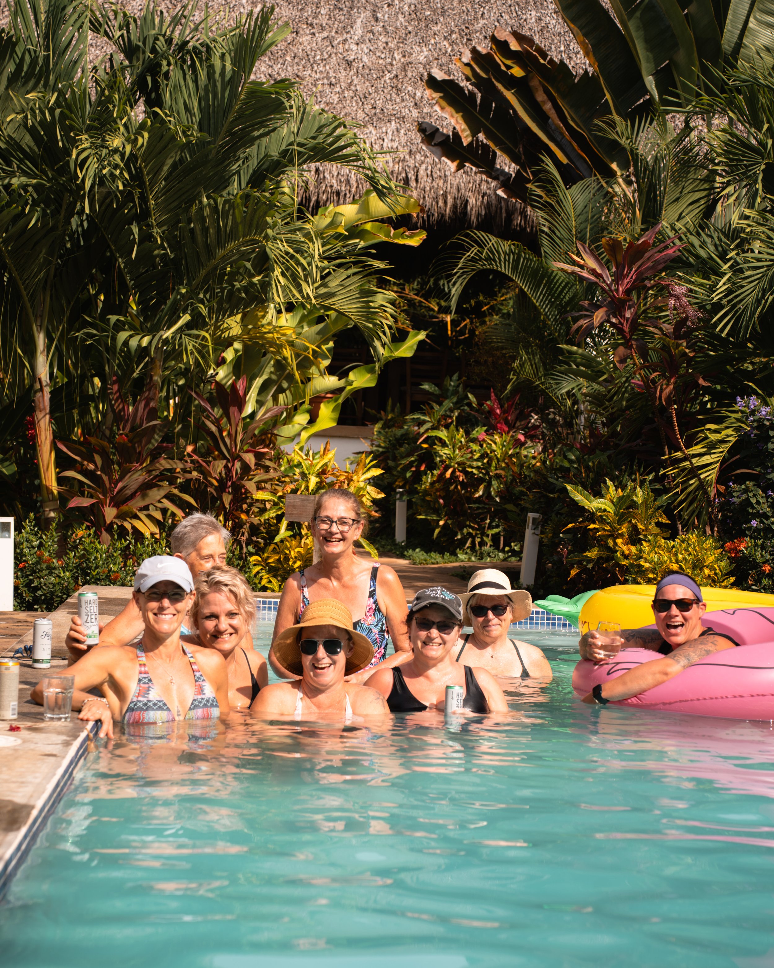 Retreat guests relaxing together in the pool on a safe surf retreat in Nicaragua