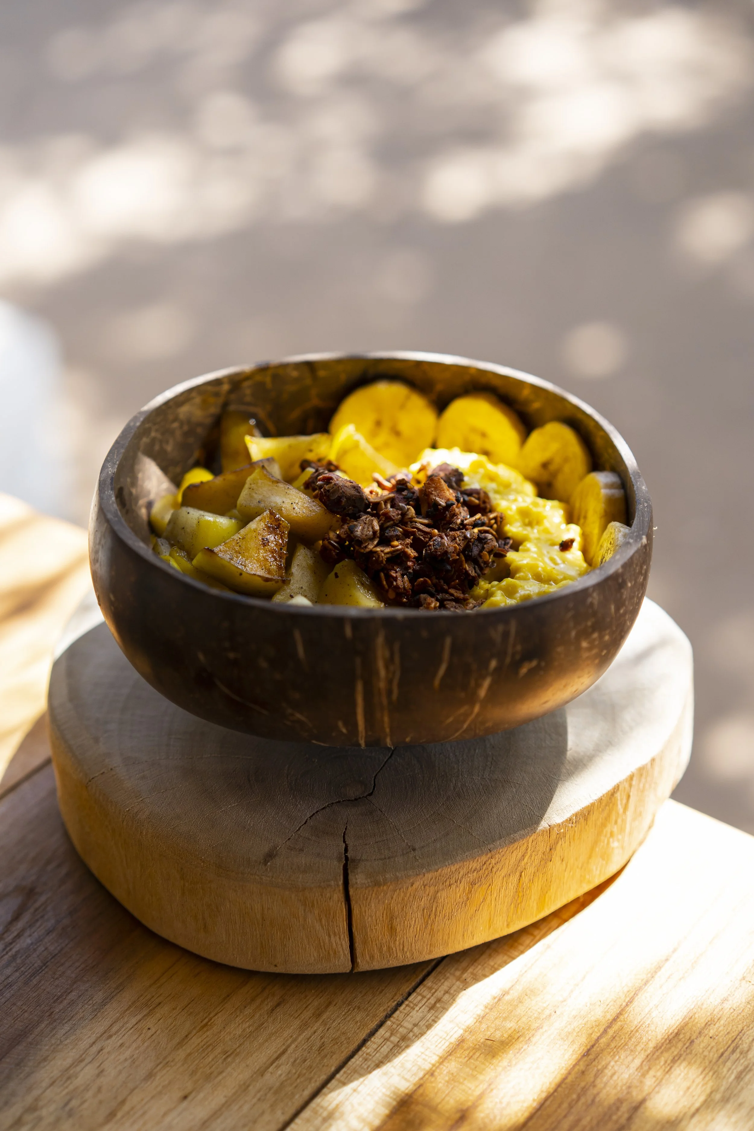 Coconut bowl with scrambled eggs, plantains, sautéed fruit, and granola at Still Salty Escape surf and yoga retreat in Nicaragua