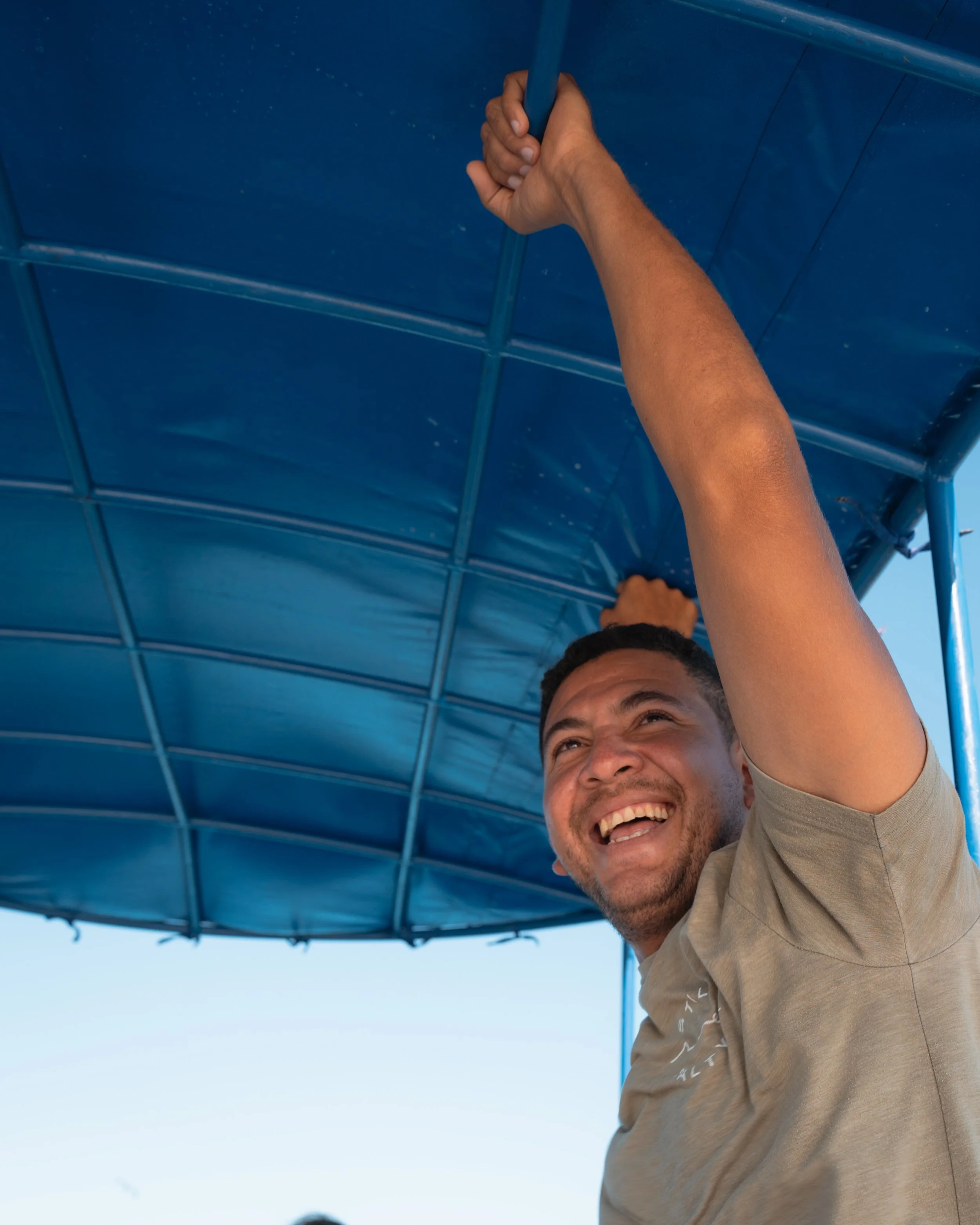 Rafa, a local guest-facing manager at Still Salty Escape, laughing aboard a boat excursion in Nicaragua