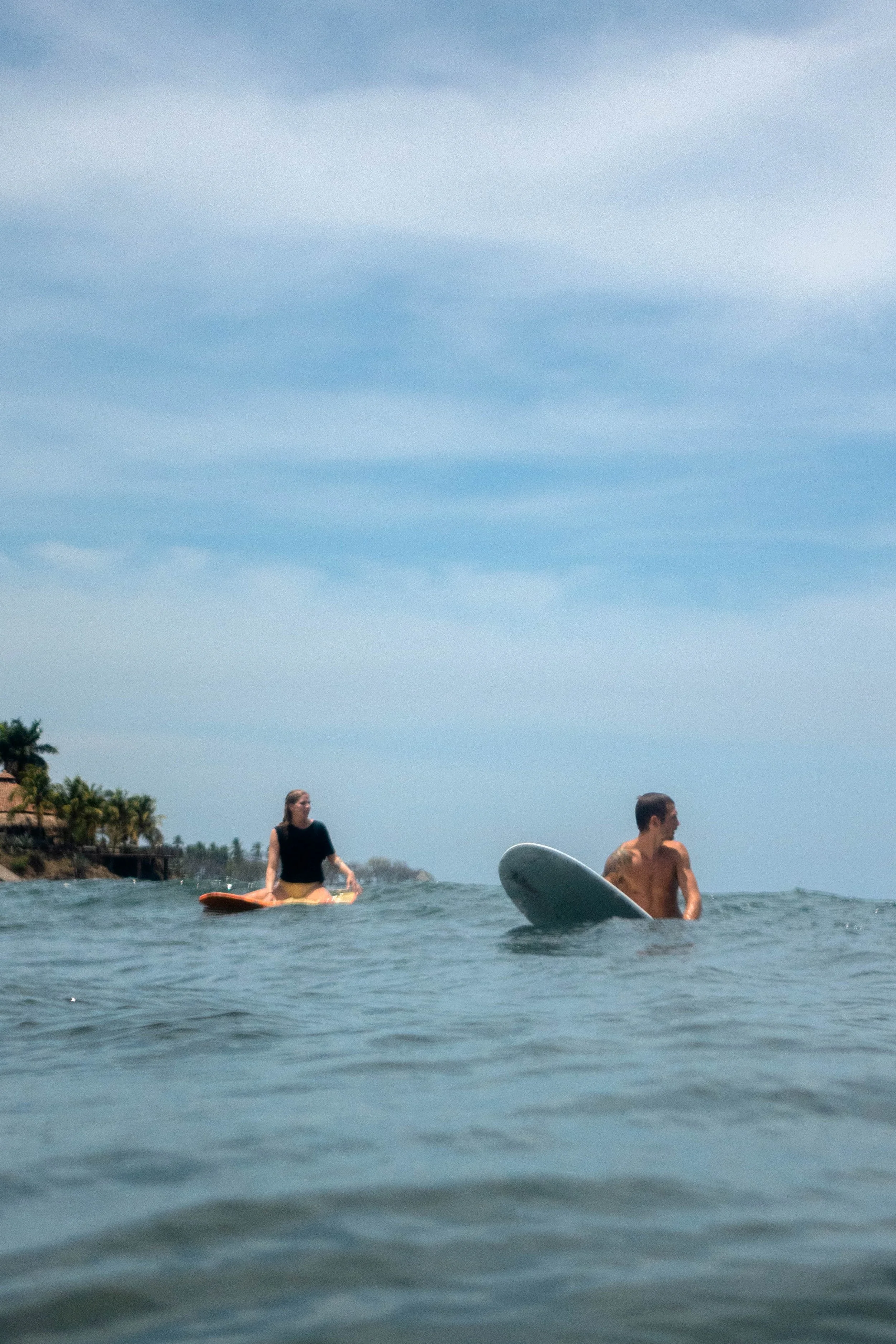 Two surfers enjoying the uncrowded waves together on a safe surf trip in Nicaragua