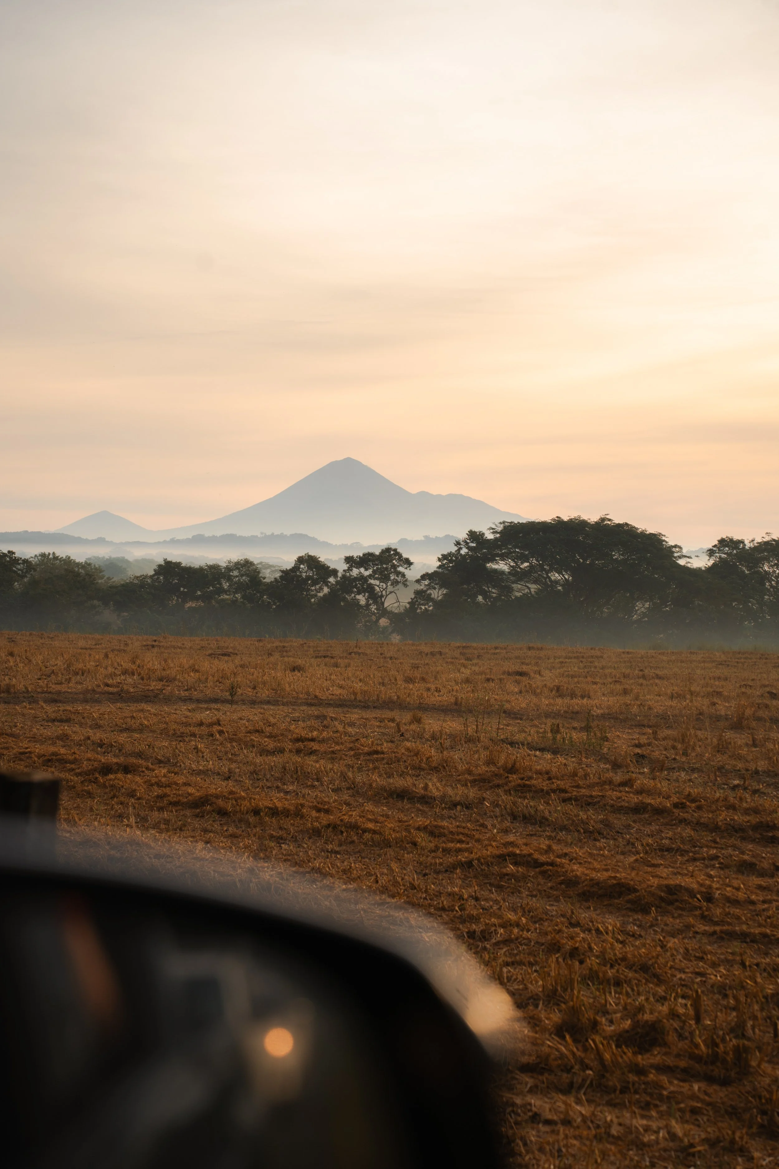 Volcano rising over the countryside at sunrise, seen from the road on the drive through Nicaragua
