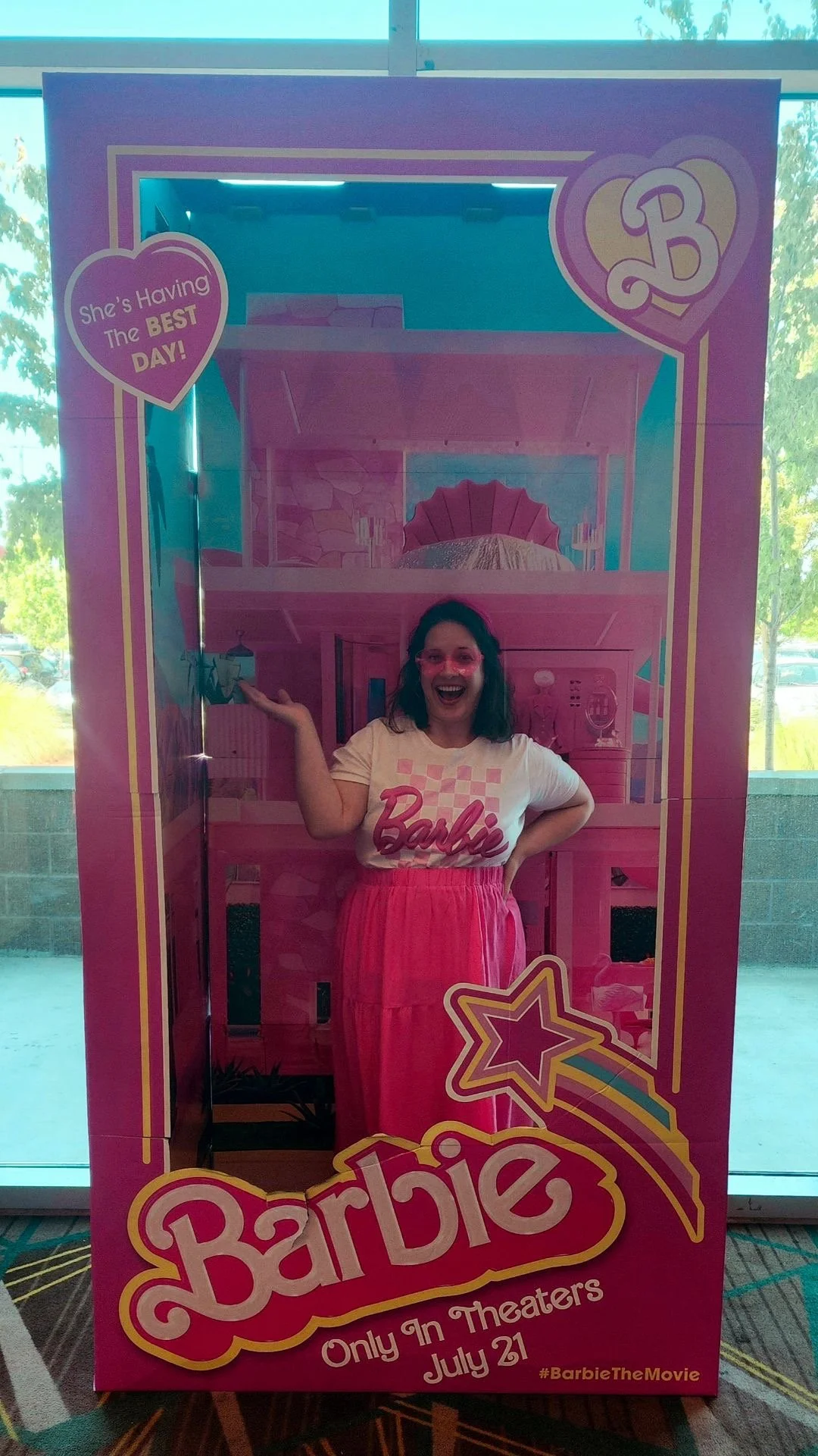 Child psychologist stands in a Barbie Box wearing a Barbie outfit