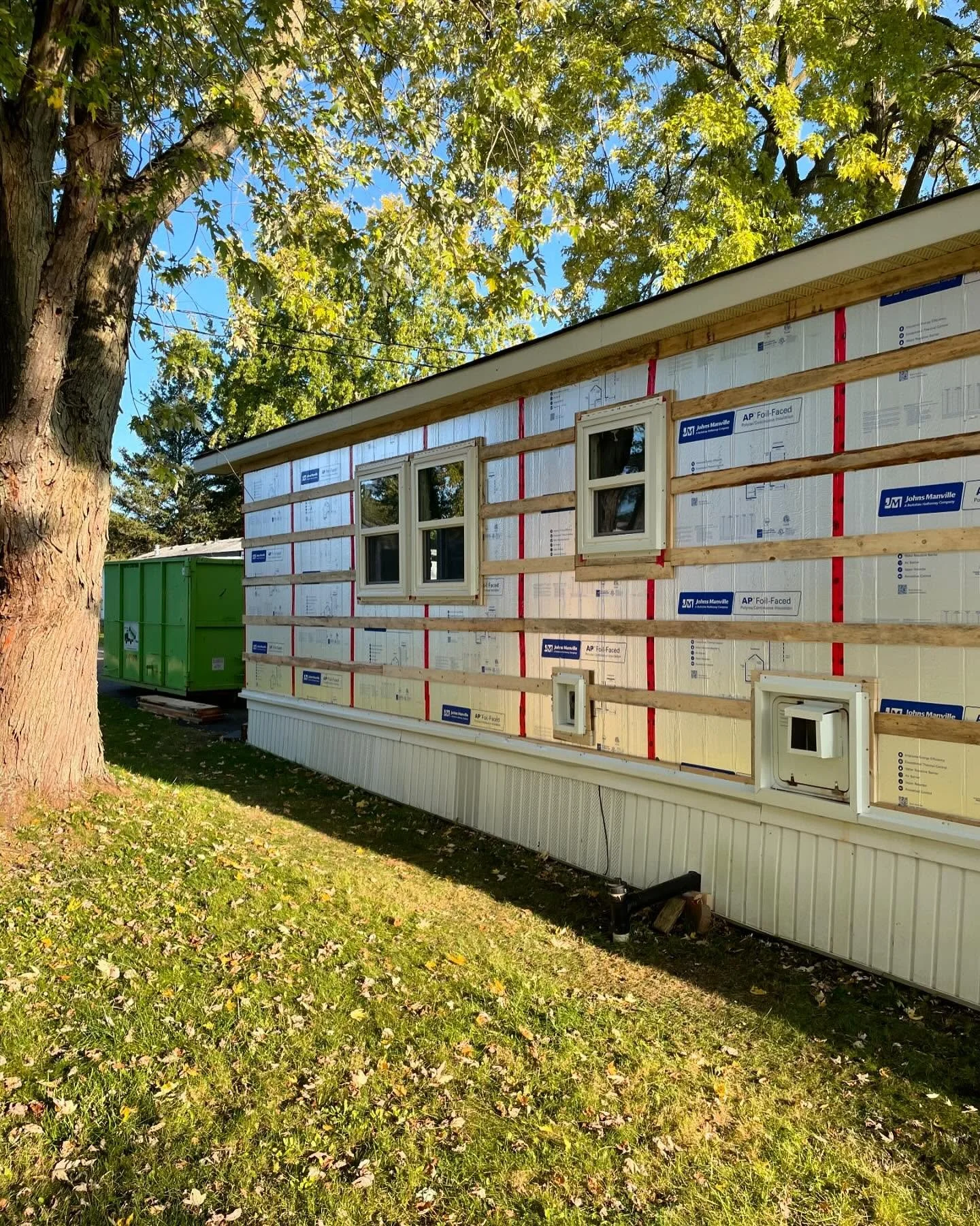 Residential construction project with exterior insulation and framing underway by Triumphant Custom Contracting.