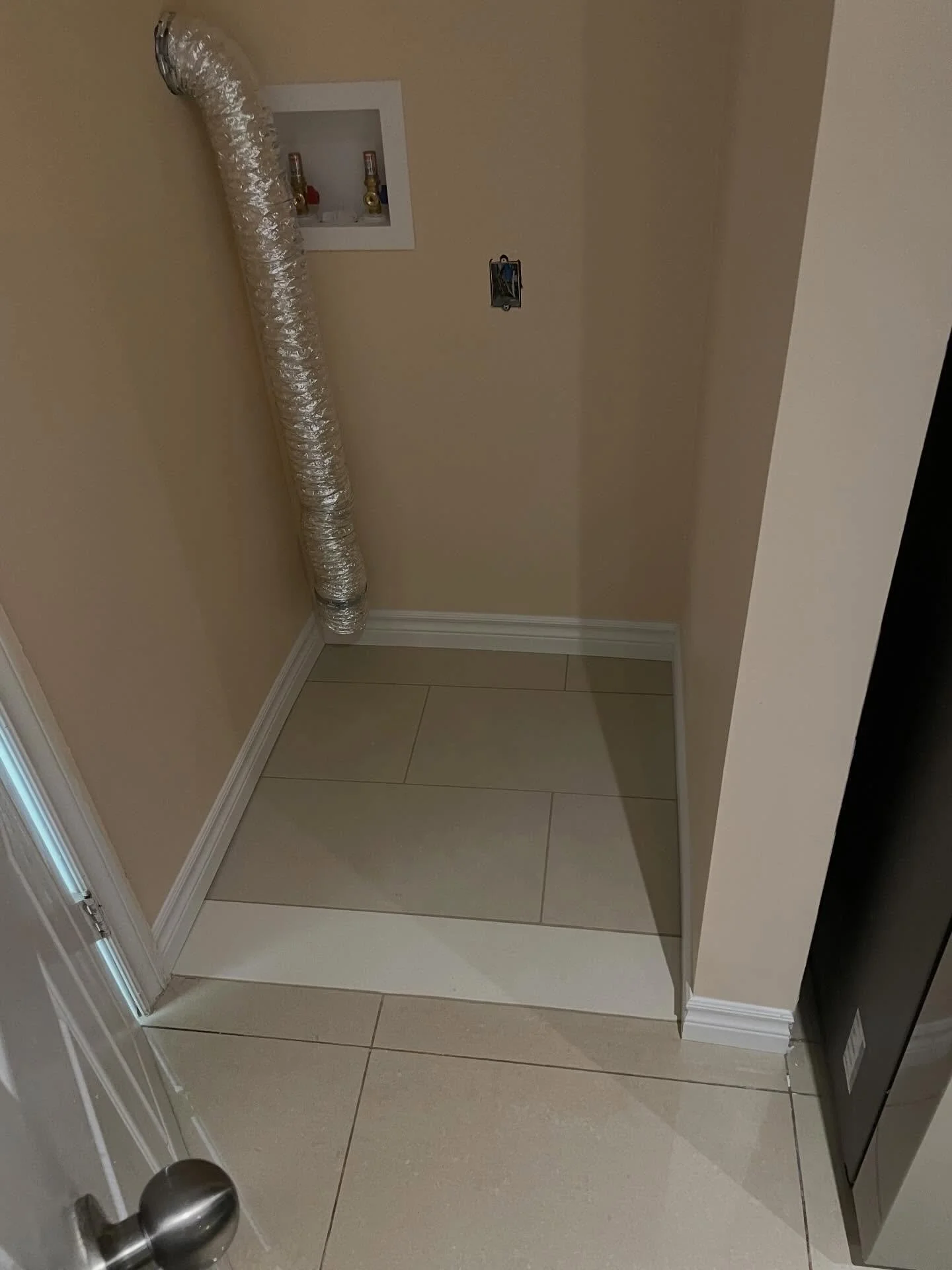 Tile and baseboard in ready for laundry