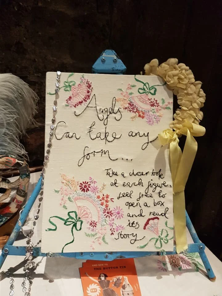the hand stitched exhibition notice saying angels can take any form