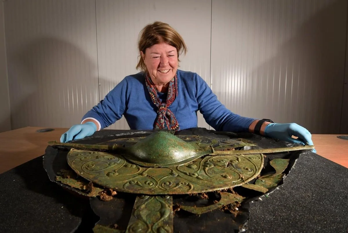 archaeologist with the iron age shield found at pocklington