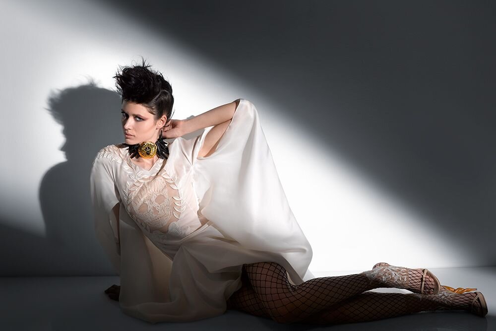 Photographer Francis Hills captures a fashion model in the spotlight. Wearing couture fashion it was shot for an editorial in Francis Hills' studio in New York City.
