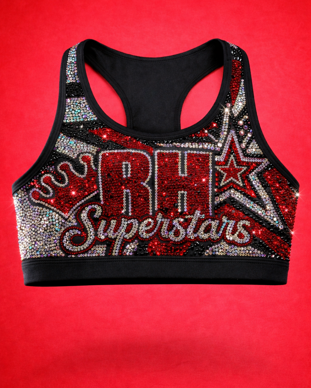 Colorful sports bra decorated with red, white, silver, and black rhinestones, featuring the words 'Superstar' and 'Rising' with star designs on a red background.