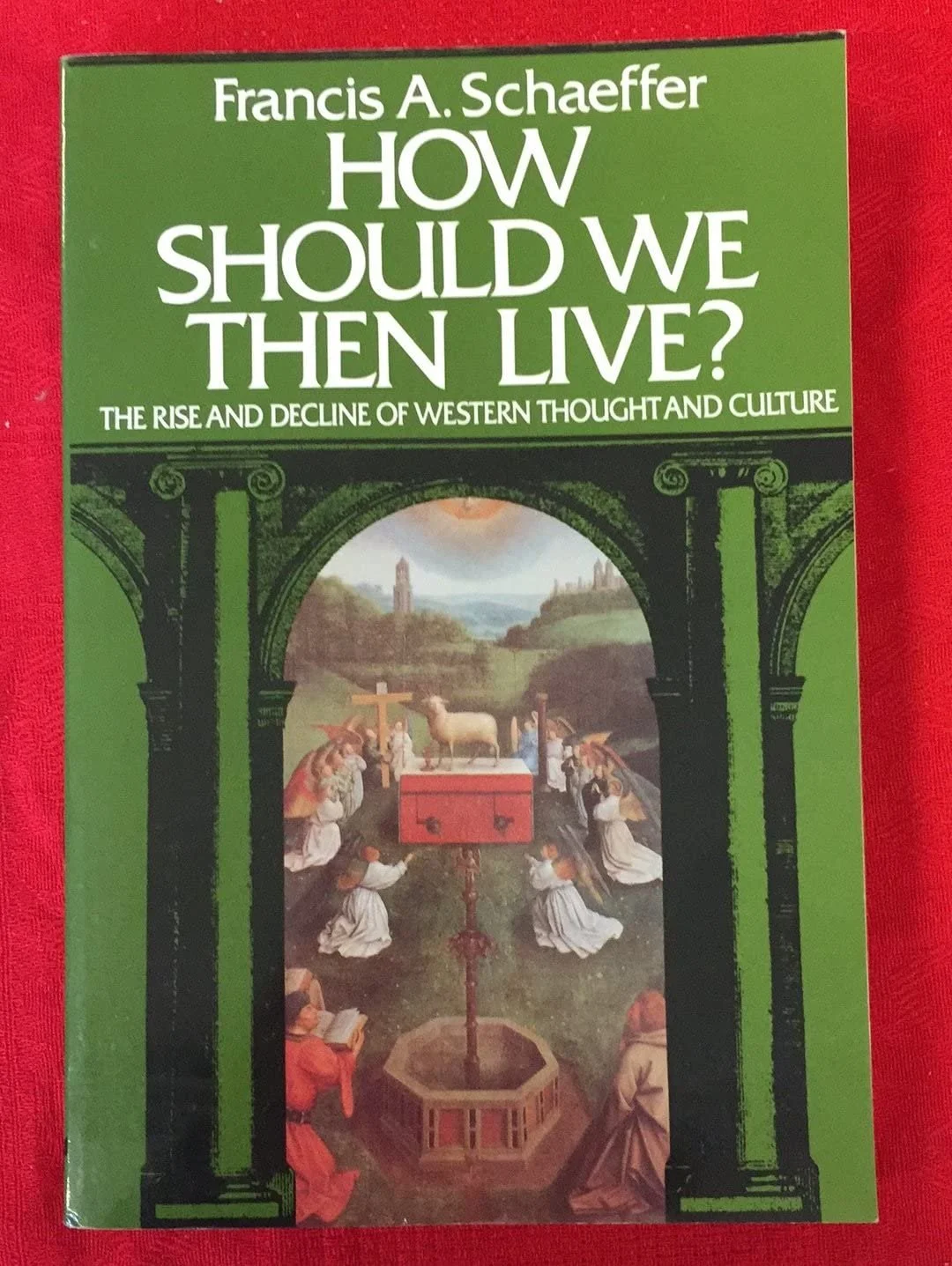 Book cover titled "How Should We Then Live?" by Francis A. Schaeffer, with subtitle "The Rise and Decline of Western Thought and Culture," featuring religious imagery and a landscape painting.