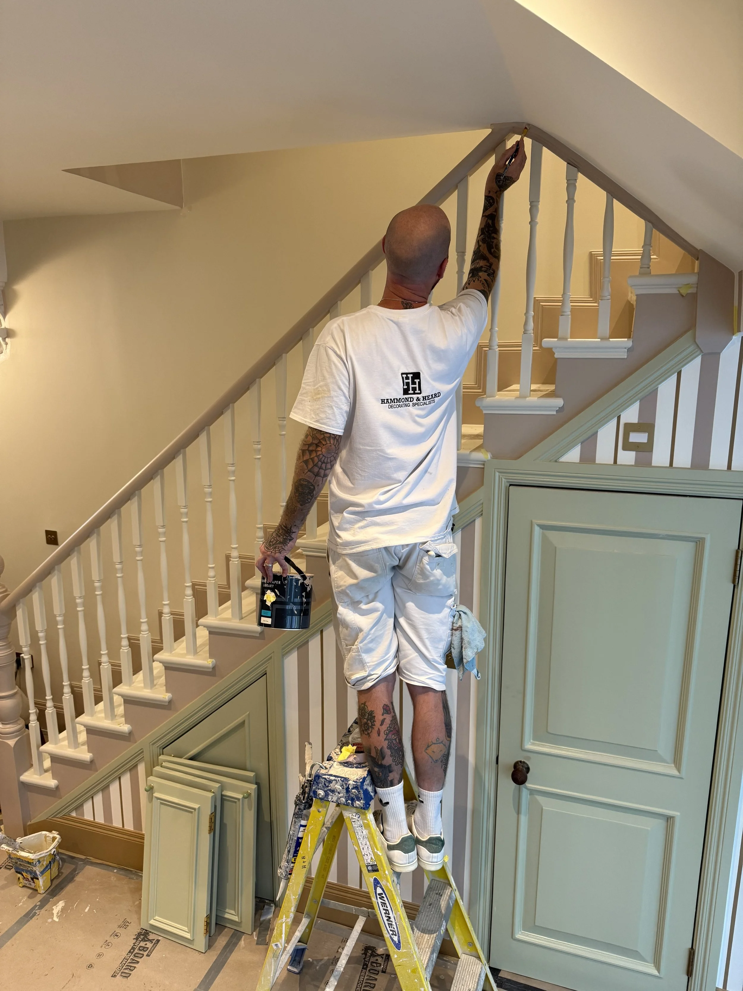 Team from Hammond & Heard redecorating room painting walls and ceiling details